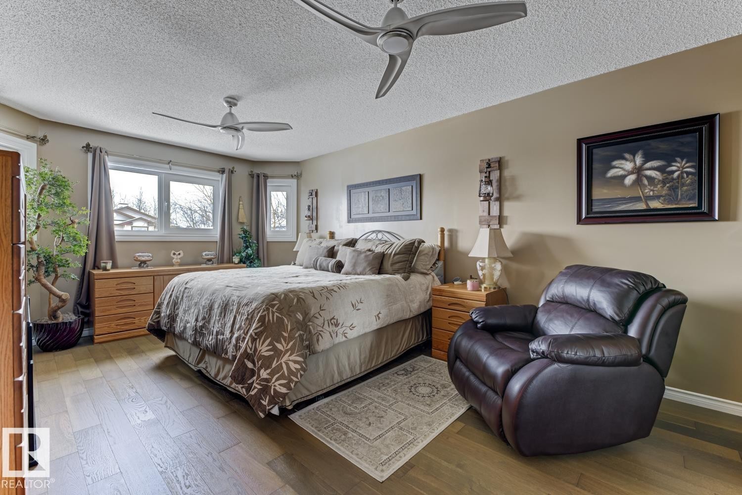Bedroom featuring wood-type flooring, a textured ceiling, and ceiling fan - 20148 46 Avenue, Edmonton, AB - Indoor Photo Showing Bedroom