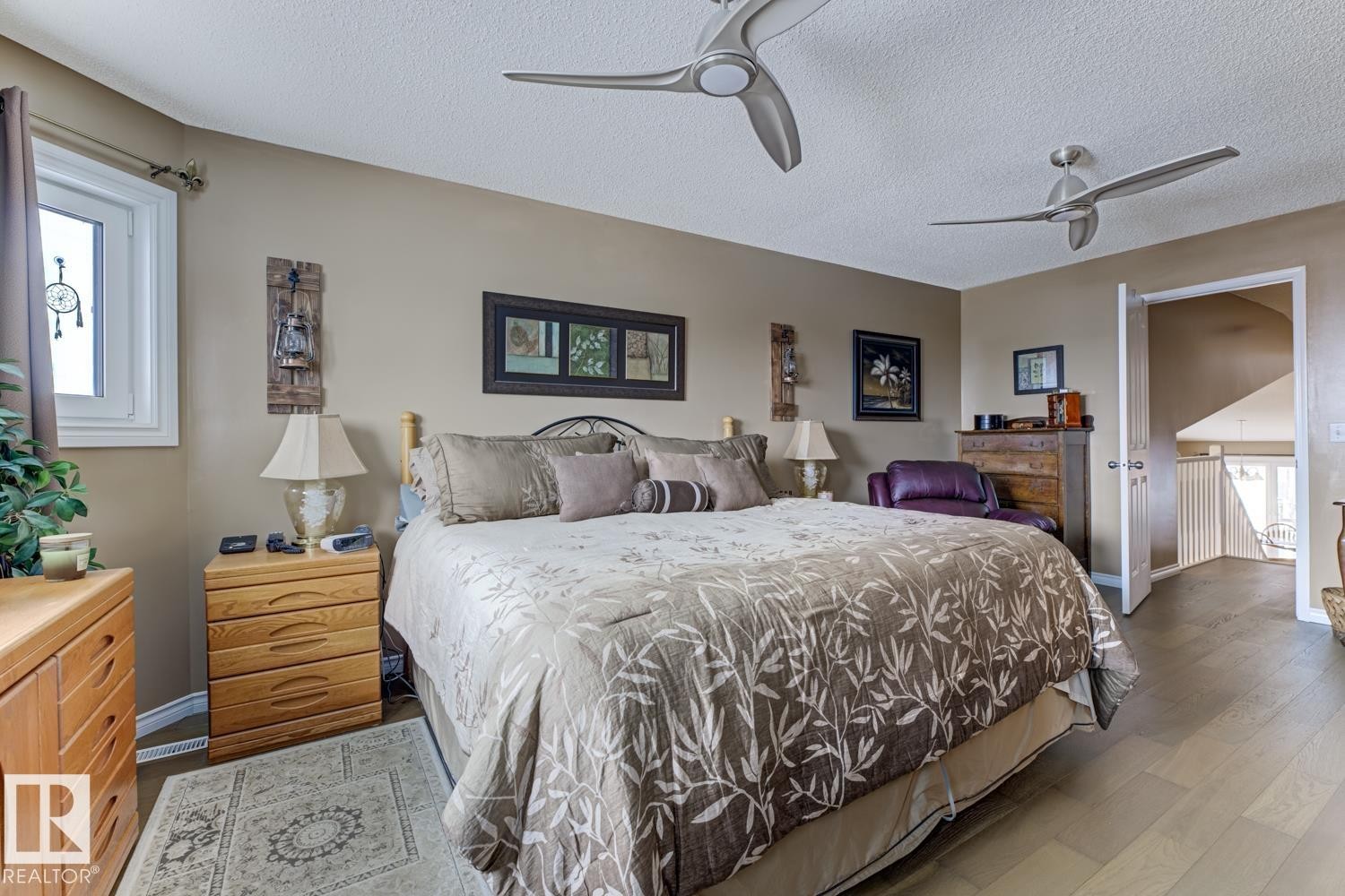 Bedroom featuring a ceiling fan, a textured ceiling, and wood finished floors - 20148 46 Avenue, Edmonton, AB - Indoor Photo Showing Bedroom