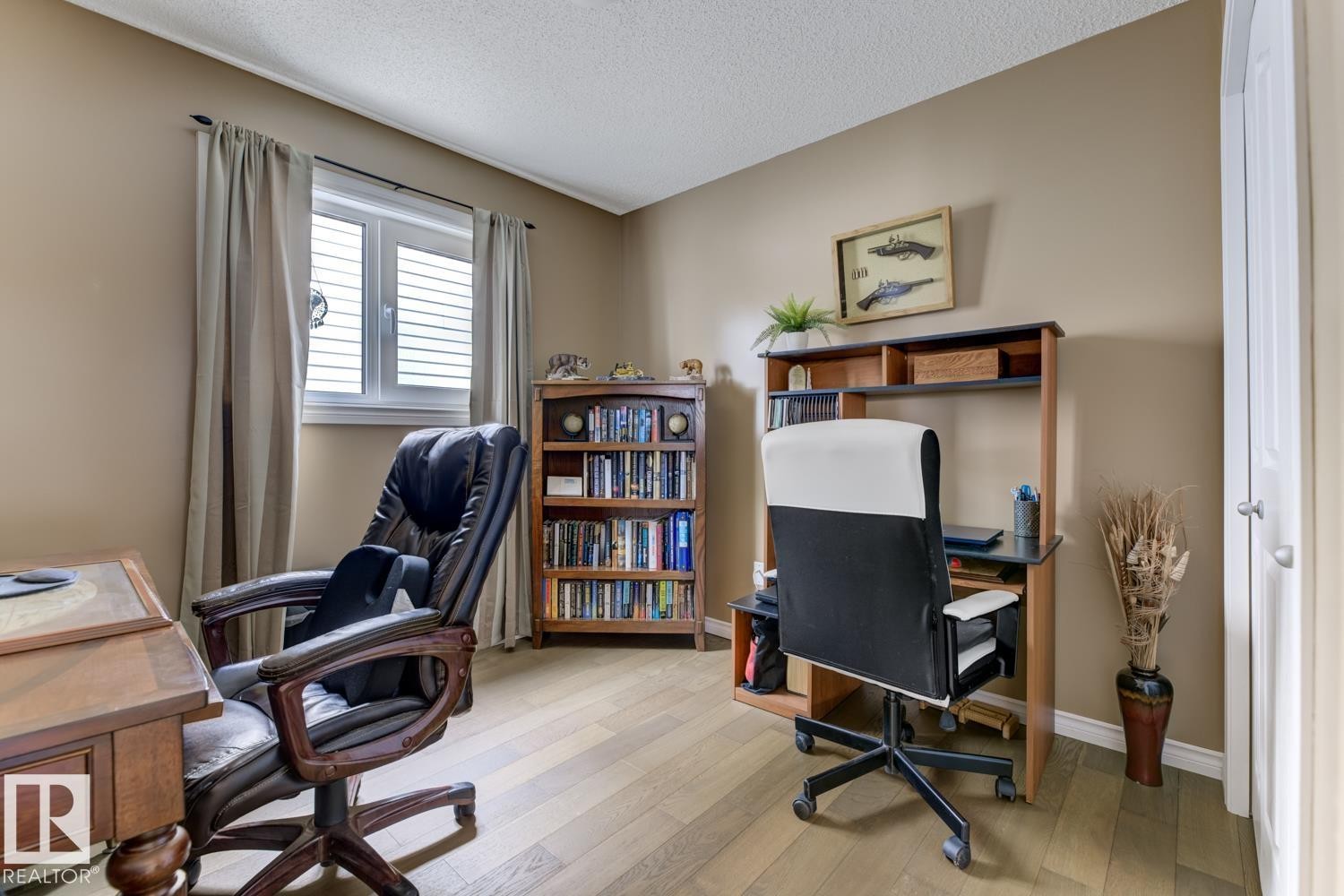Office area featuring light wood finished floors and a textured ceiling - 20148 46 Avenue, Edmonton, AB - Indoor Photo Showing Office