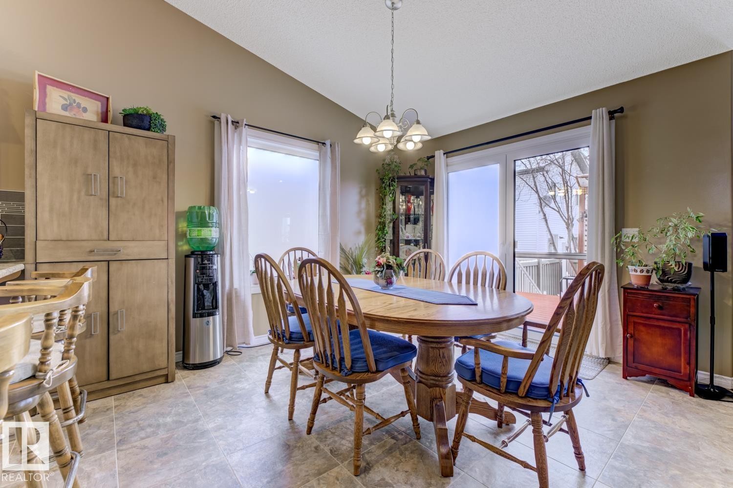 Dining space featuring a chandelier, vaulted ceiling, and plenty of natural light - 20148 46 Avenue, Edmonton, AB - Indoor Photo Showing Dining Room