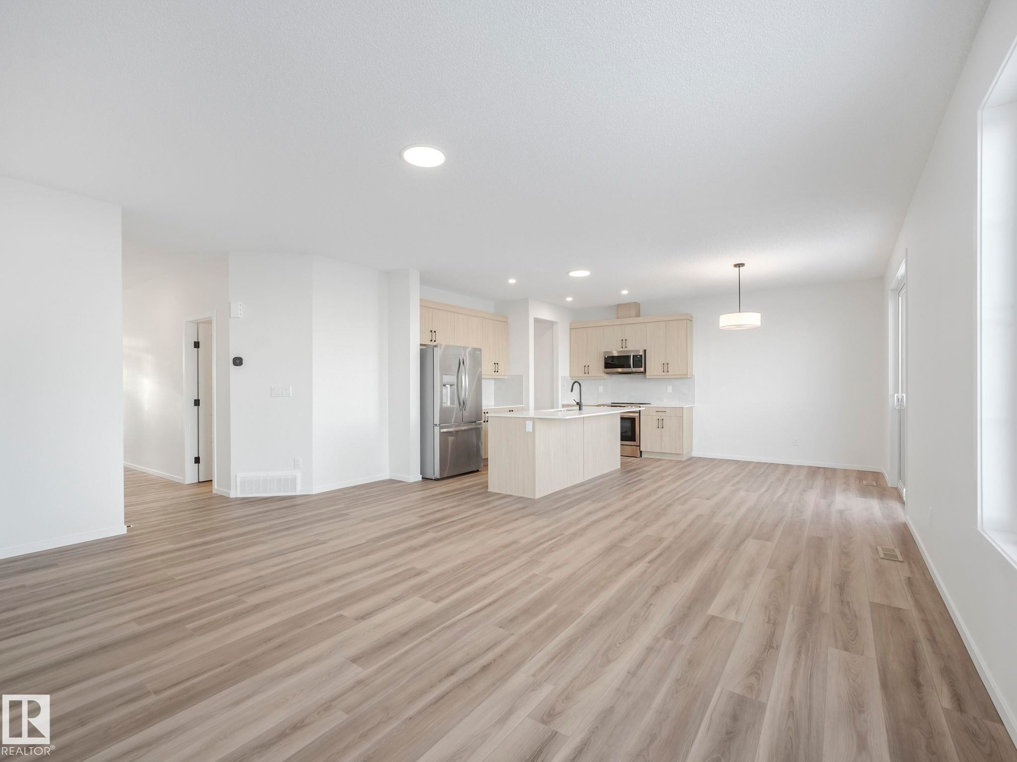 Unfurnished living room with recessed lighting and light wood-type flooring - 20506 16A Avenue, Edmonton, AB - Indoor