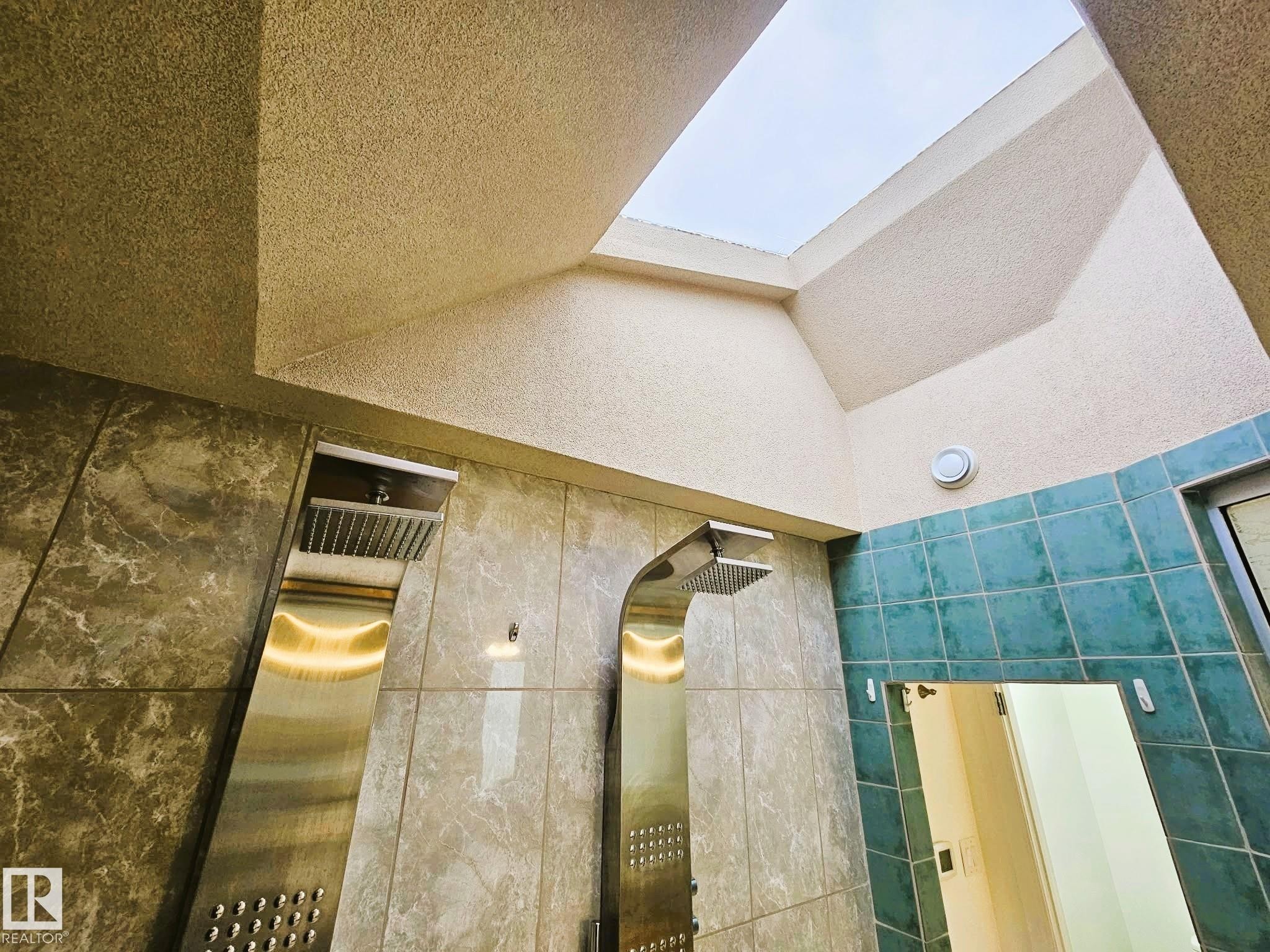 Bathroom view of tile walls, a skylight, a tile shower, dual showers! - 8512 131 Avenue, Edmonton, AB -