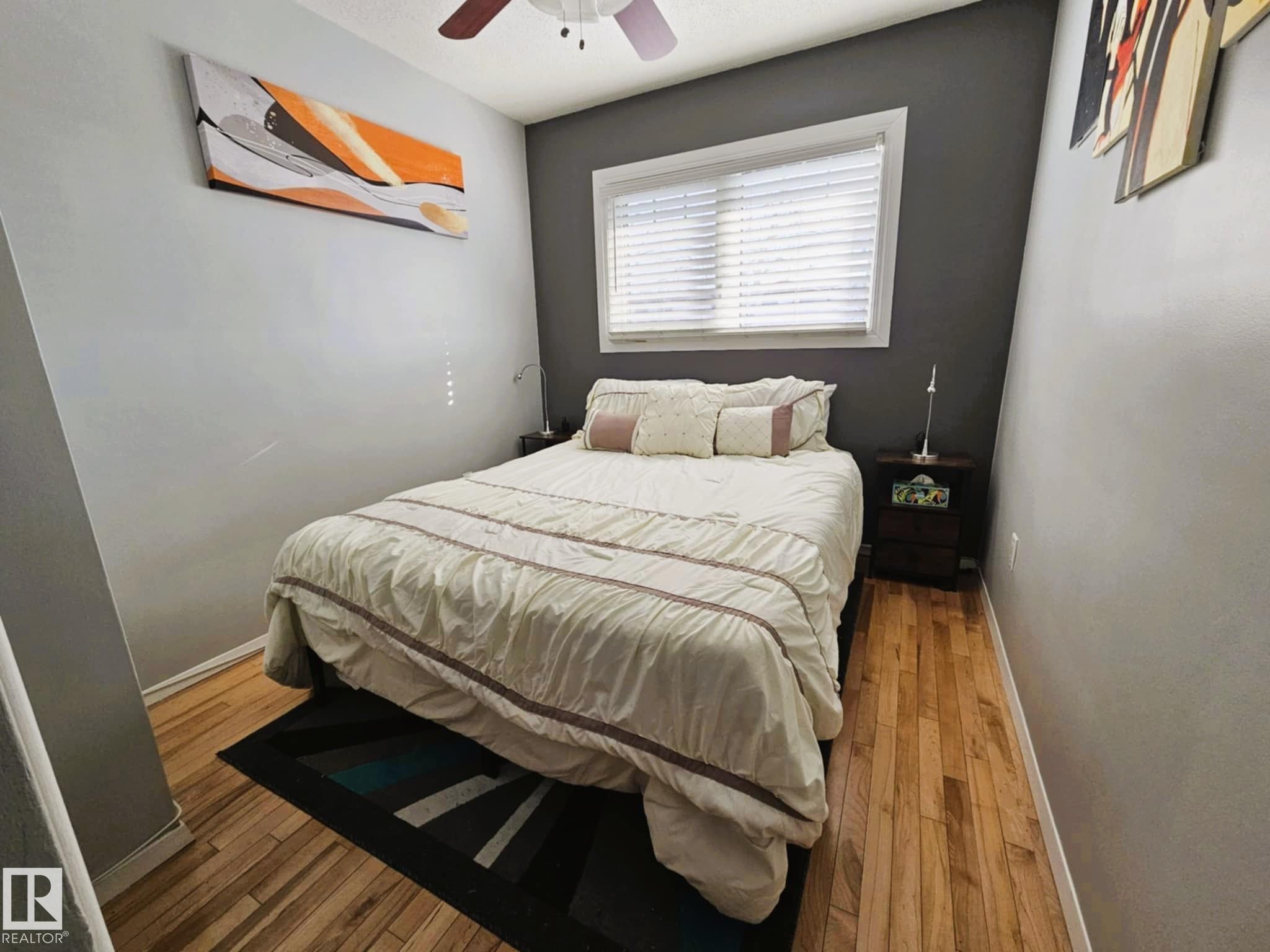 Bedroom featuring hardwood / wood-style floors and ceiling fan - 8512 131 Avenue, Edmonton, AB - Indoor Photo Showing Bedroom