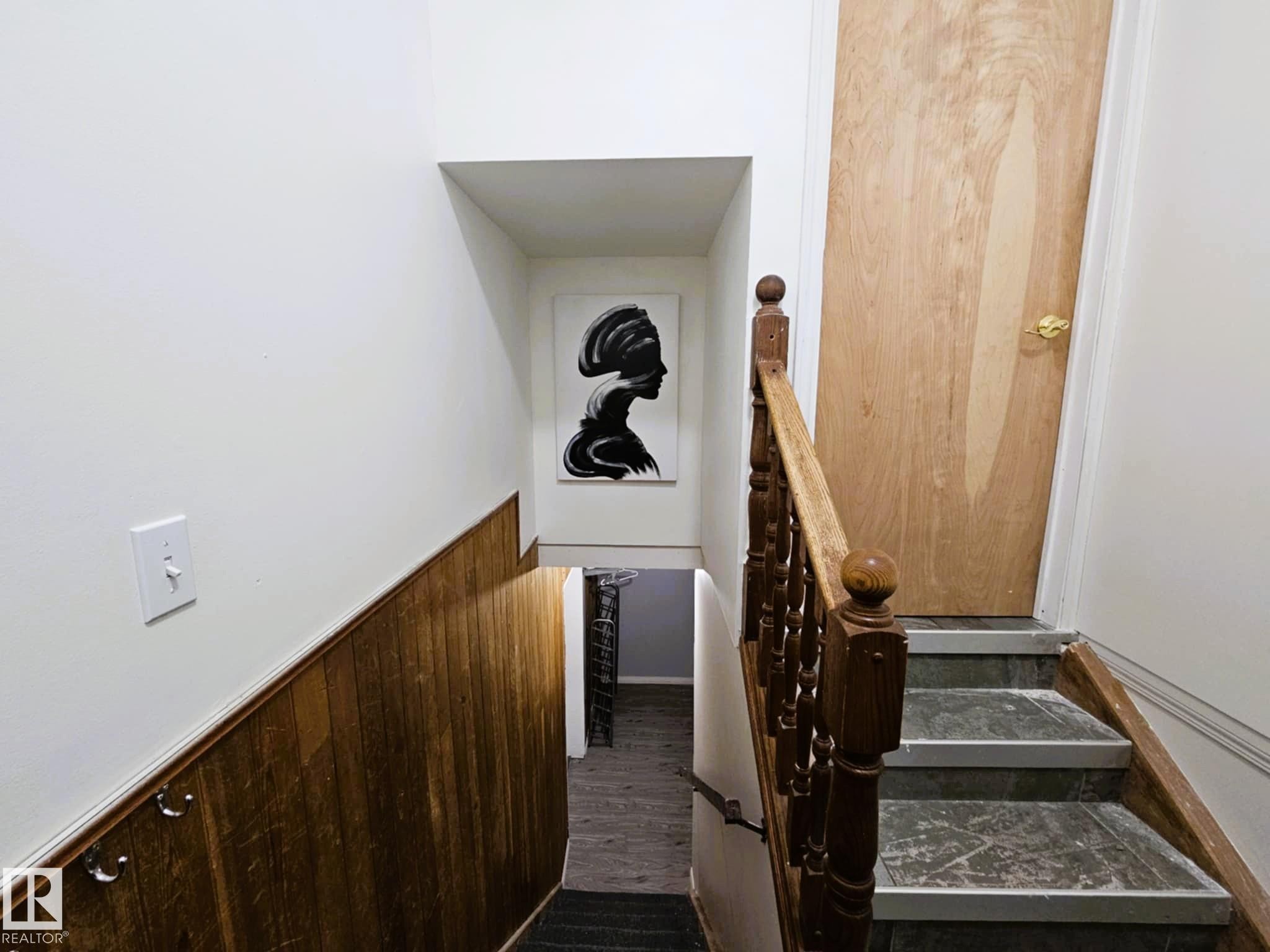 Stairs with wood finished floors, wooden walls, and wainscoting - 8512 131 Avenue, Edmonton, AB - Indoor Photo Showing Other Room