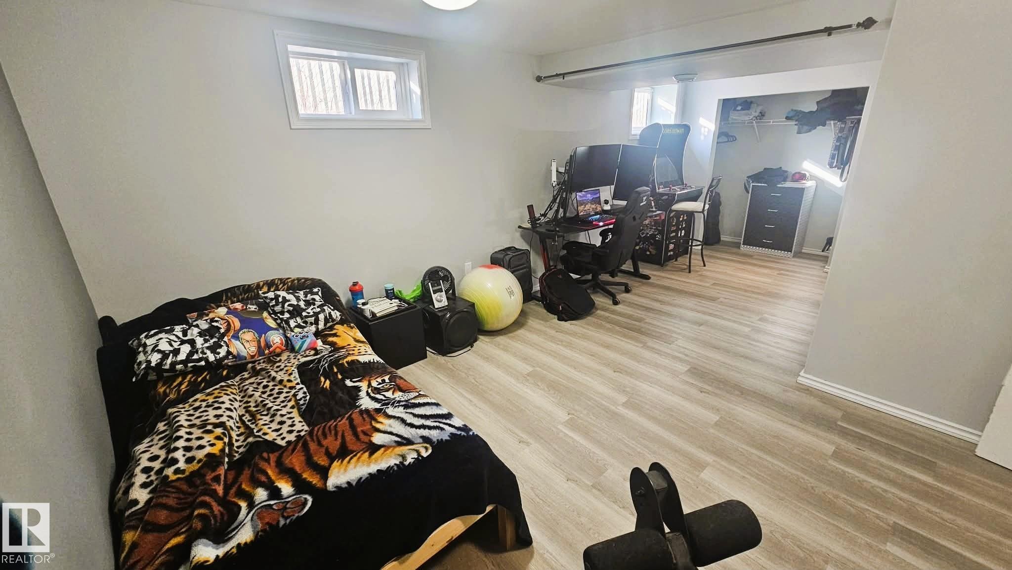 Bedroom with light wood-style floors and baseboards - 8512 131 Avenue, Edmonton, AB - Indoor