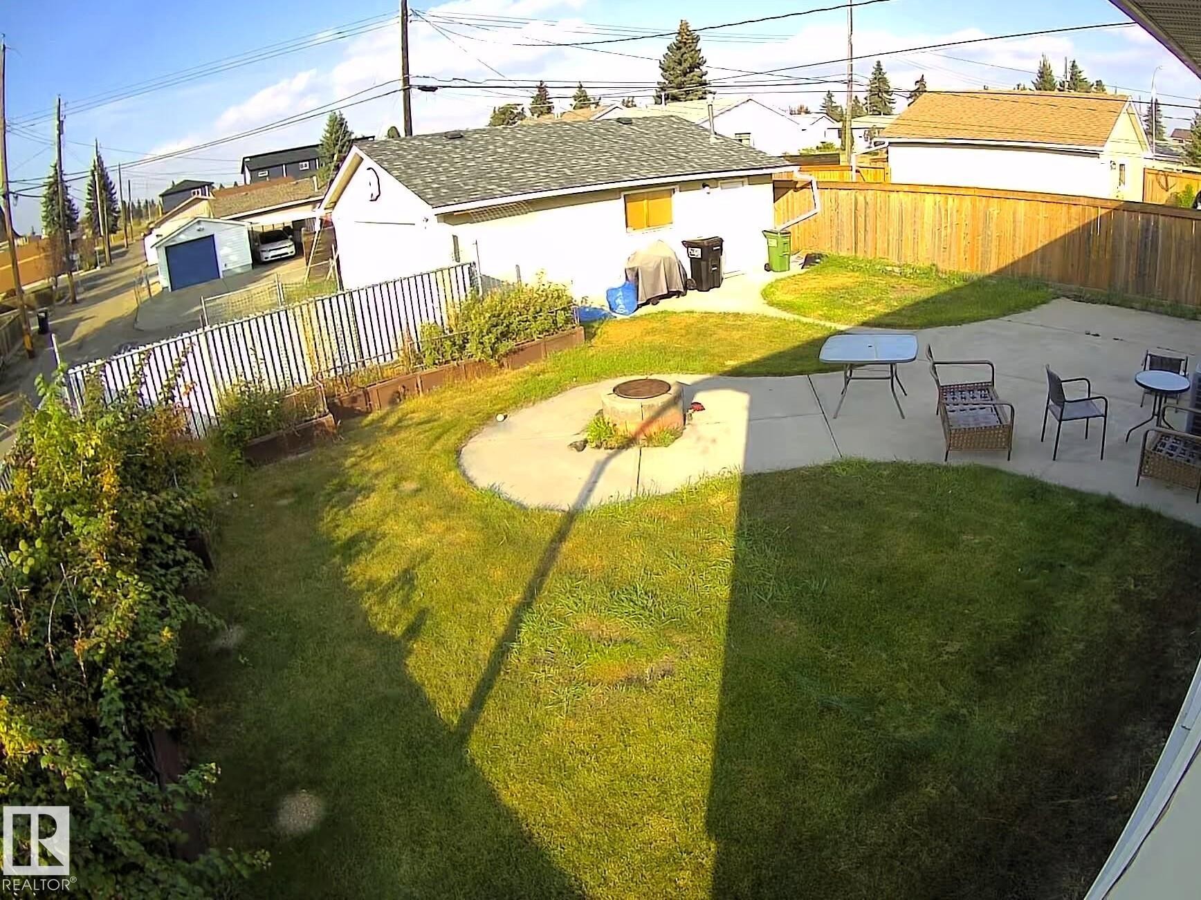 Fenced backyard with an outdoor fire pit and a patio - 8512 131 Avenue, Edmonton, AB - Outdoor