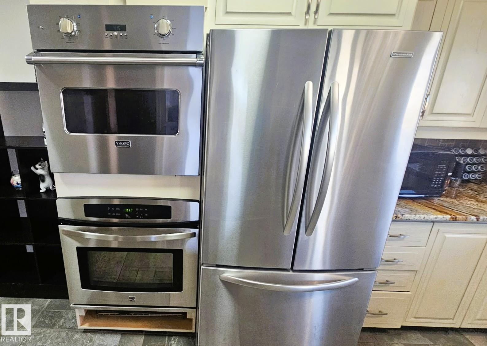 Kitchen featuring stainless steel appliances, light stone countertops, and white cabinets - 8512 131 Avenue, Edmonton, AB - Indoor Photo Showing Kitchen With Upgraded Kitchen