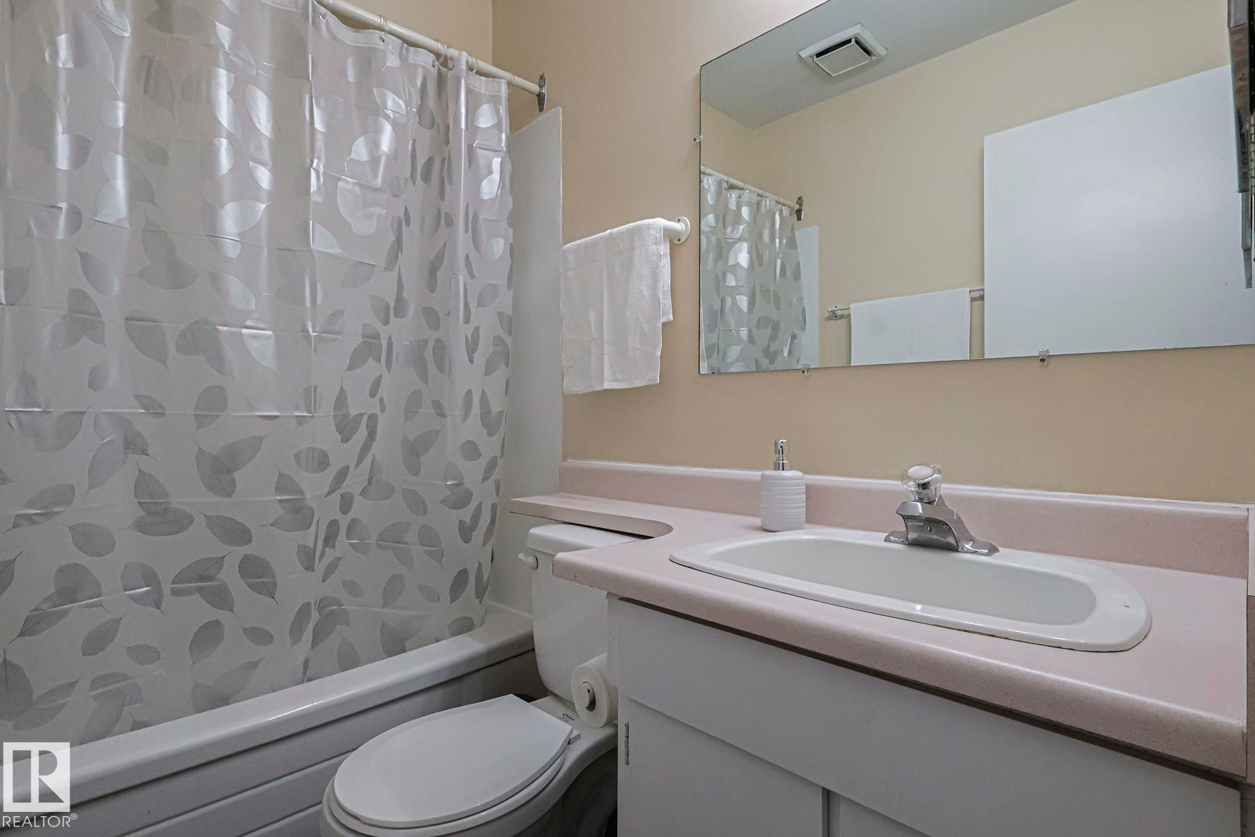 Full bath with vanity and shower / bath combo - 1526 69 Street Nw, Edmonton, AB - Indoor Photo Showing Bathroom