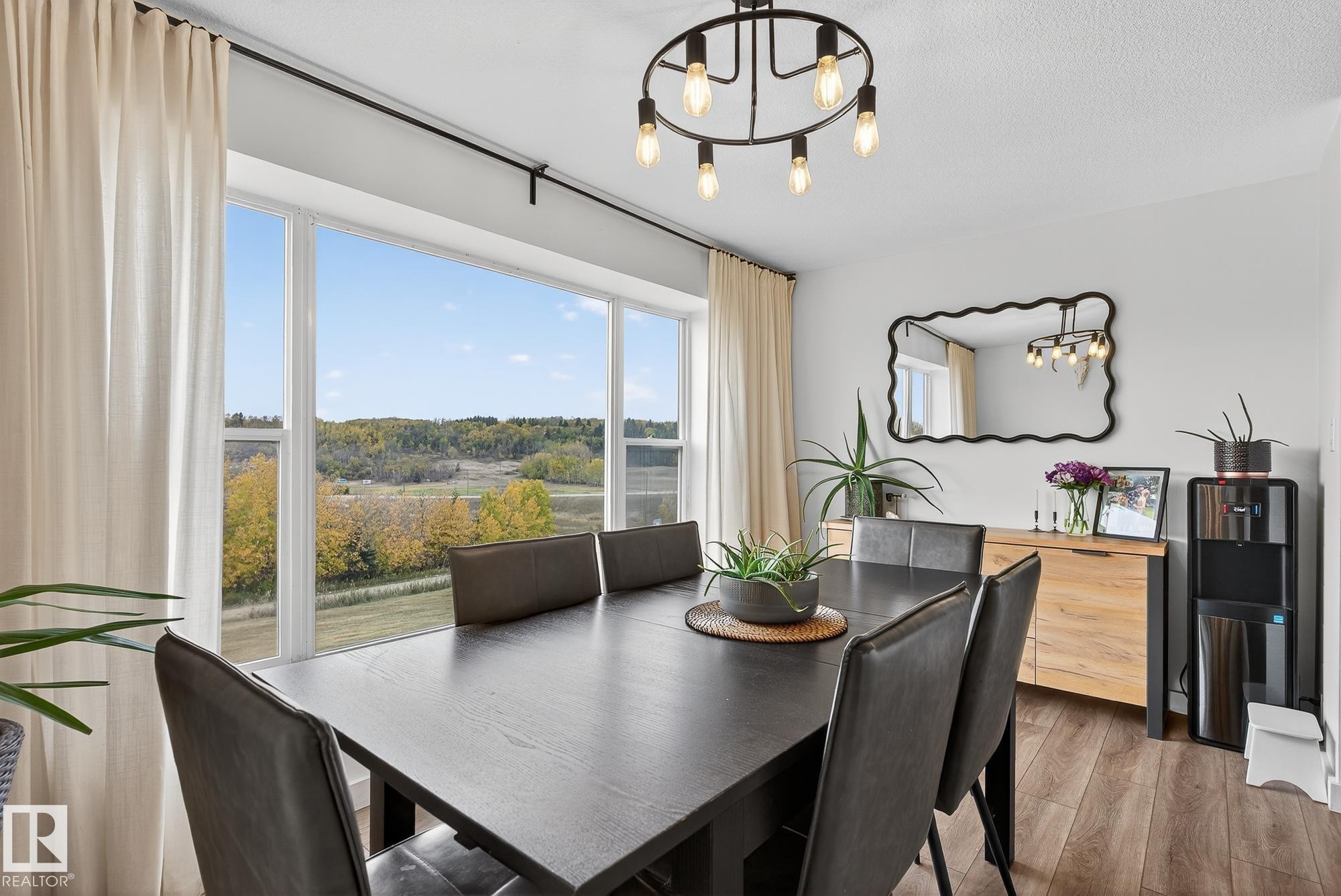 Dining area featuring a chandelier and wood finished floors - 23509A Twp Road 484, Rural Leduc County, AB - Indoor Photo Showing Dining Room