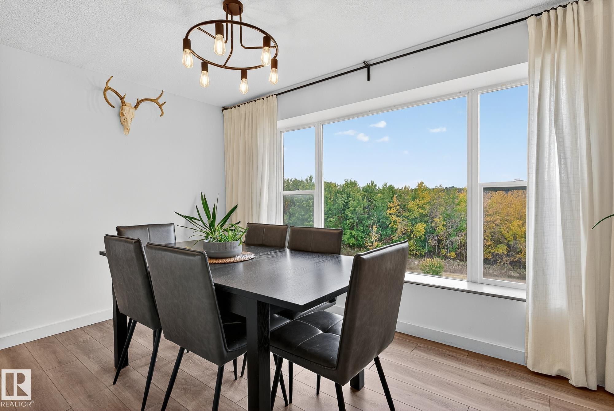 Dining room with light wood-type flooring and hanging lights - 23509A Twp Road 484, Rural Leduc County, AB - Indoor Photo Showing Dining Room