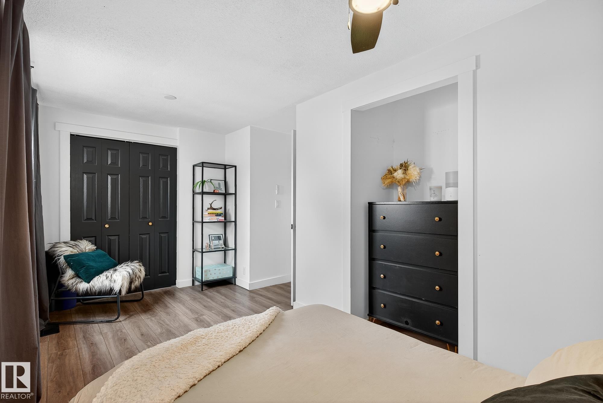 Bedroom with wood finished floors, a ceiling fan, and a closet - 23509A Twp Road 484, Rural Leduc County, AB - Indoor Photo Showing Bedroom