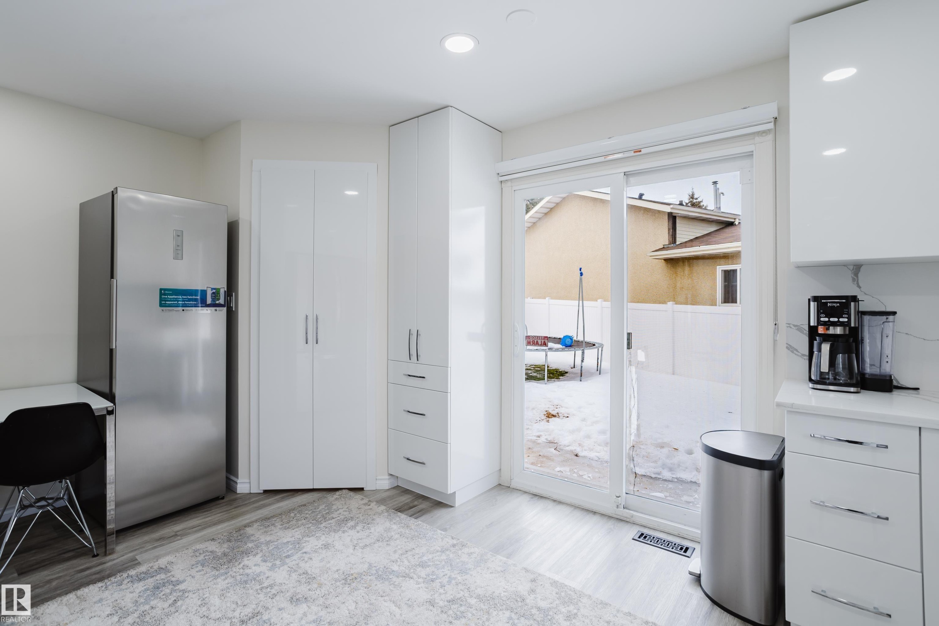 Kitchen with freestanding refrigerator, white cabinets, light countertops, light wood-style flooring, and recessed lighting - 236 Lago Lindo Crescent, Edmonton, AB - Indoor Photo Showing Other Room