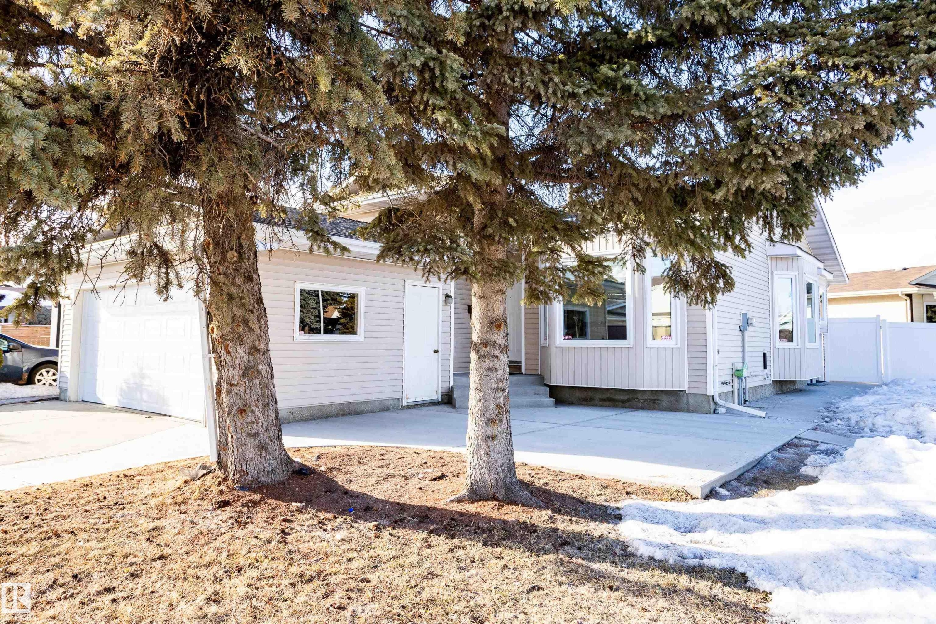 View of front of property featuring a garage, a patio, and concrete driveway - 236 Lago Lindo Crescent, Edmonton, AB - Outdoor