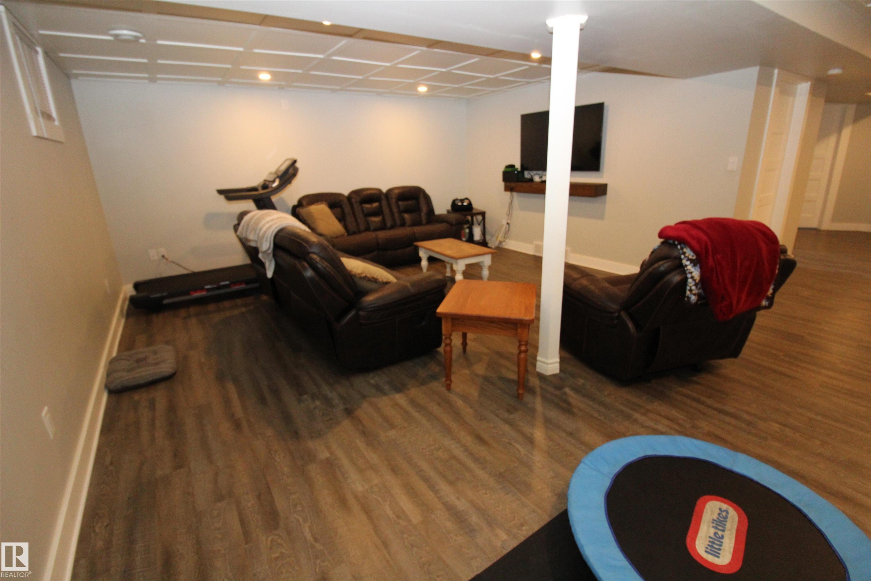 Living area featuring dark wood finished floors and recessed lighting - 10319 106 Ave, Westlock, AB - Indoor