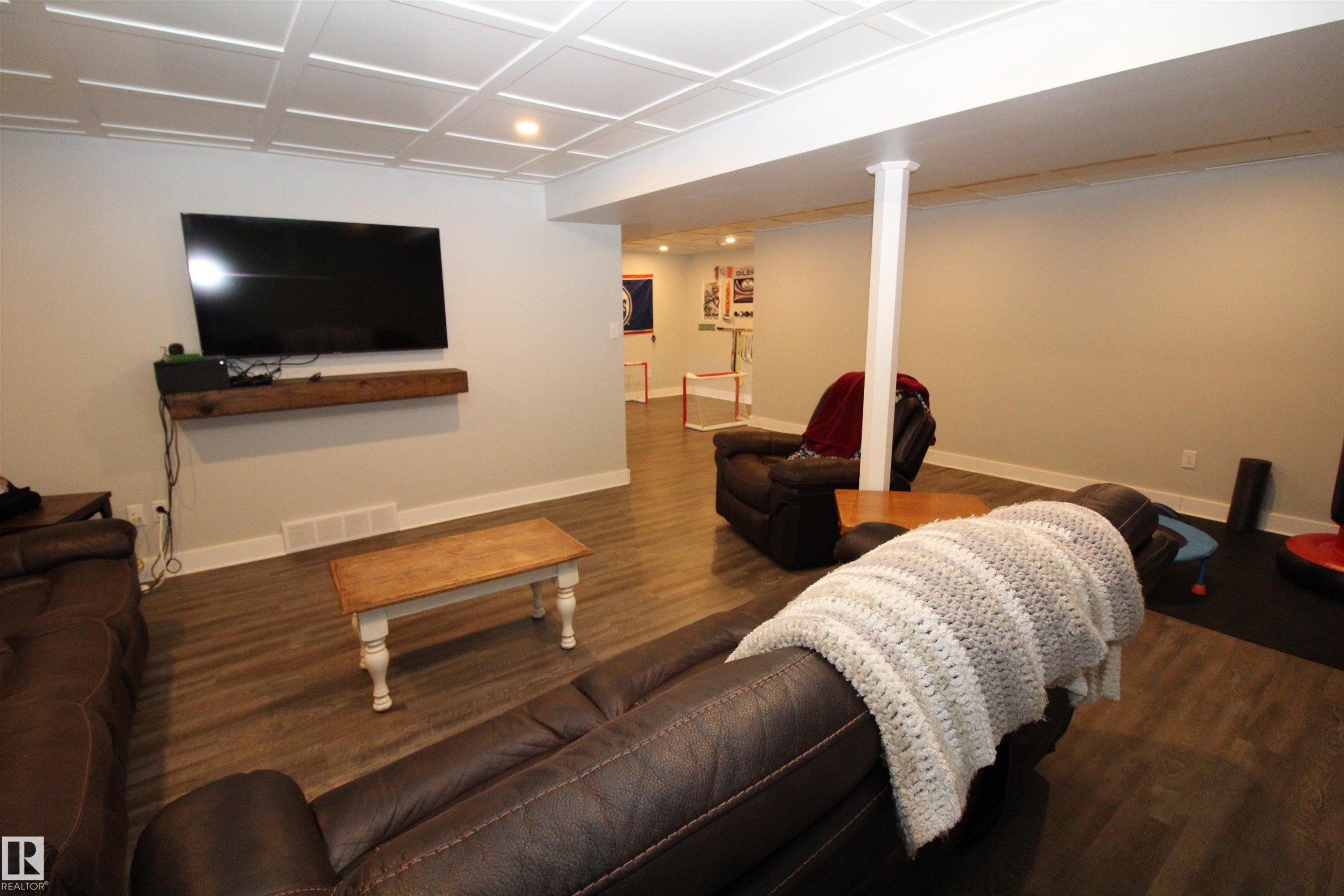 Living room with wood finished floors and recessed lighting - 10319 106 Ave, Westlock, AB - Indoor