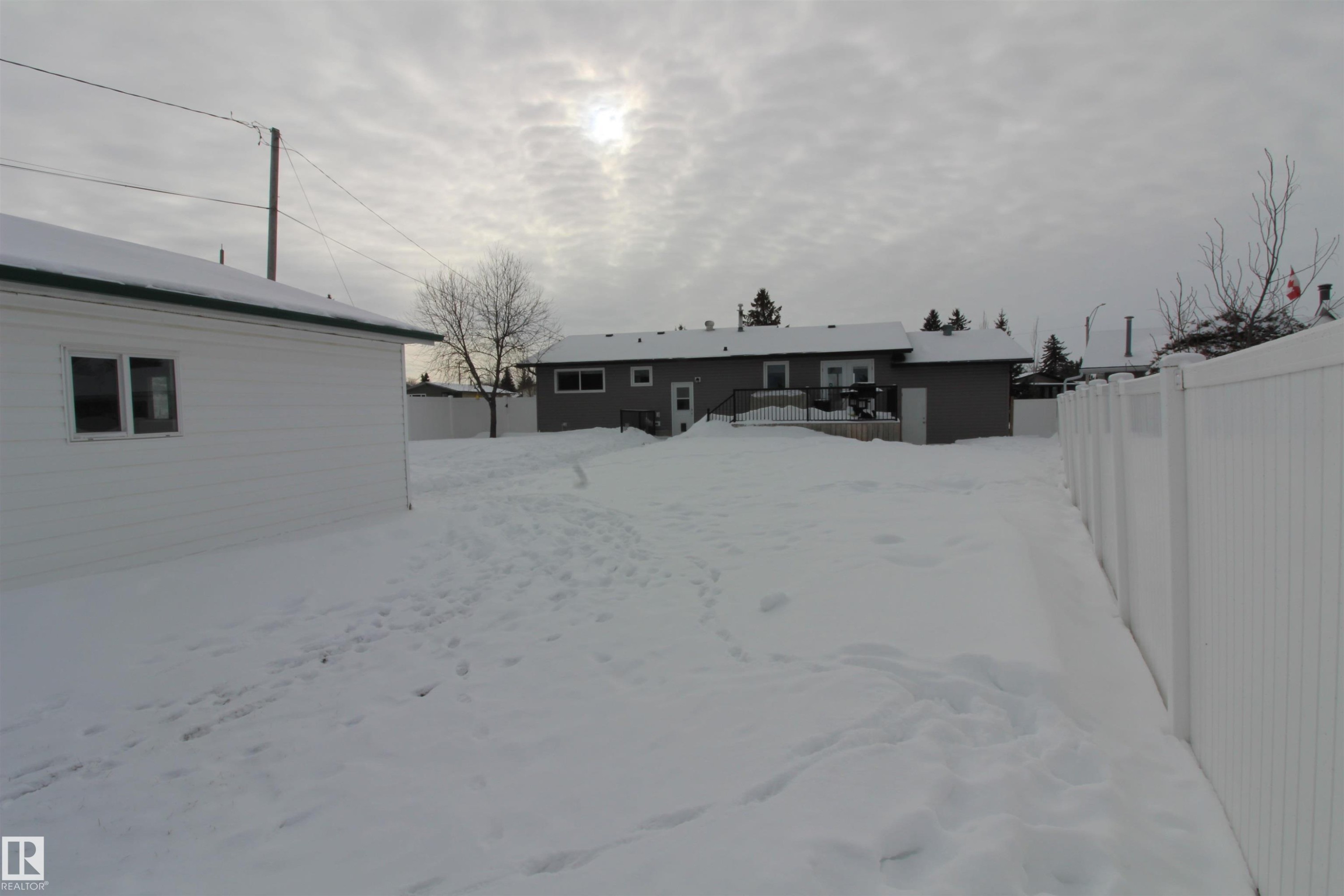 Back of house with a wooden deck - 10319 106 Ave, Westlock, AB - Outdoor