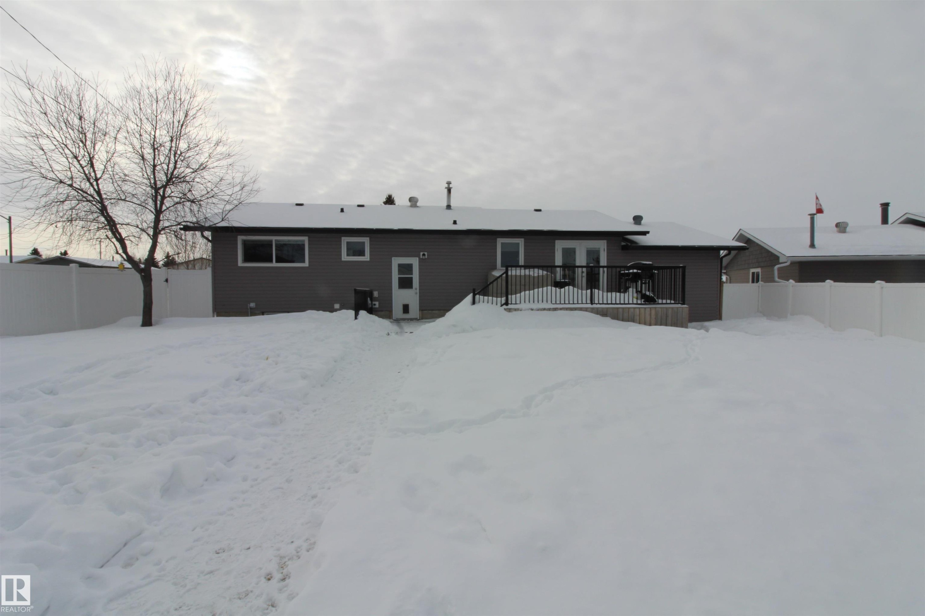 Back of property with a wooden deck - 10319 106 Ave, Westlock, AB - Outdoor