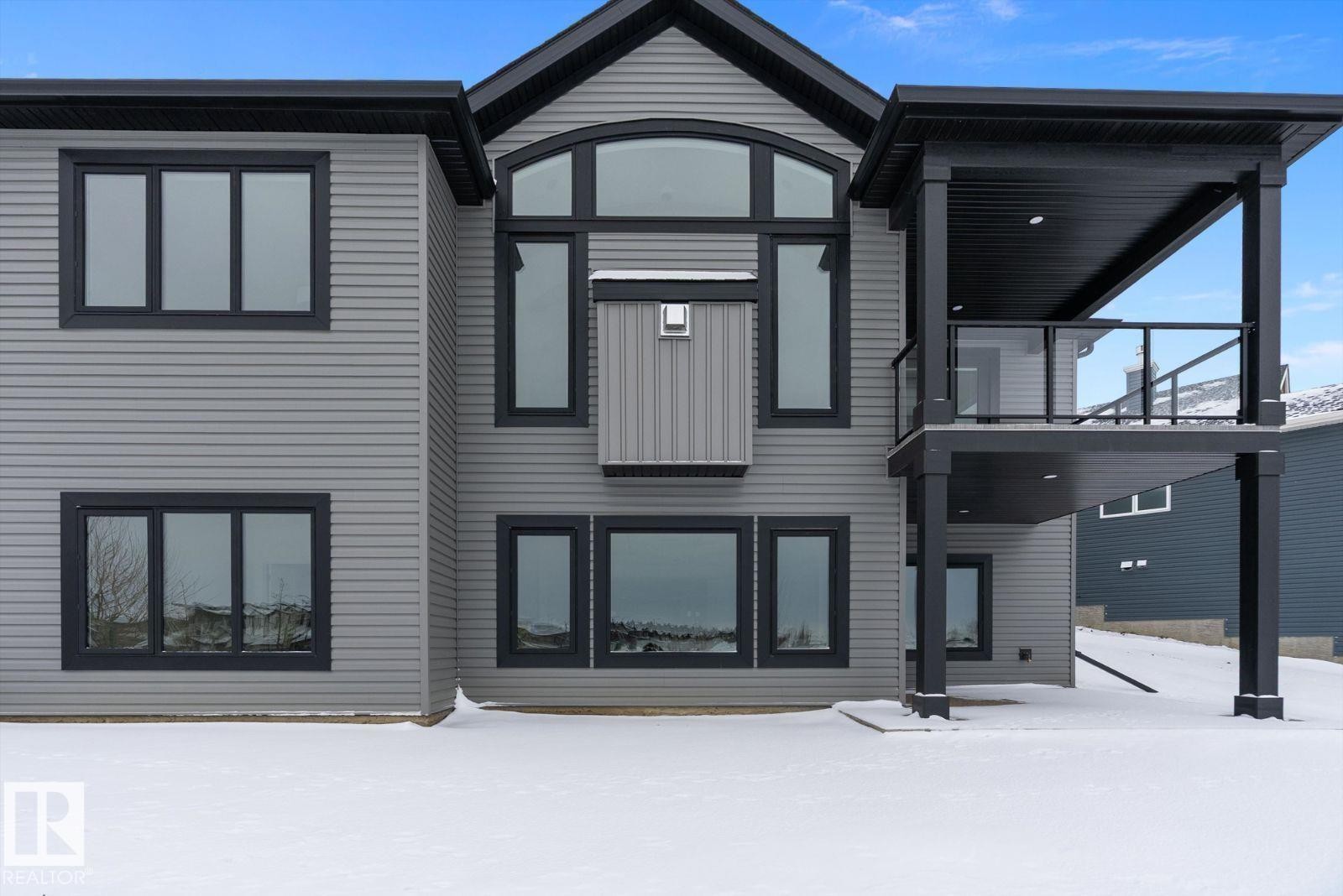 Snow covered back of property featuring a balcony - 128 Lilac Close, Leduc, AB - Outdoor