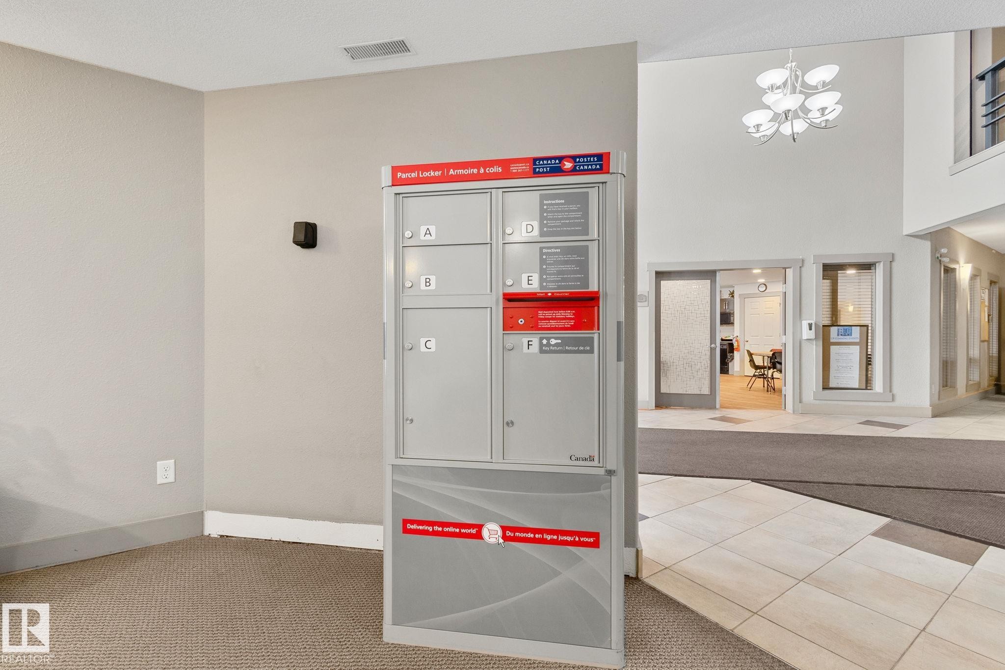 Detailed view of carpet and hanging lights - 406 16035 132 Street Nw, Edmonton, AB - Indoor
