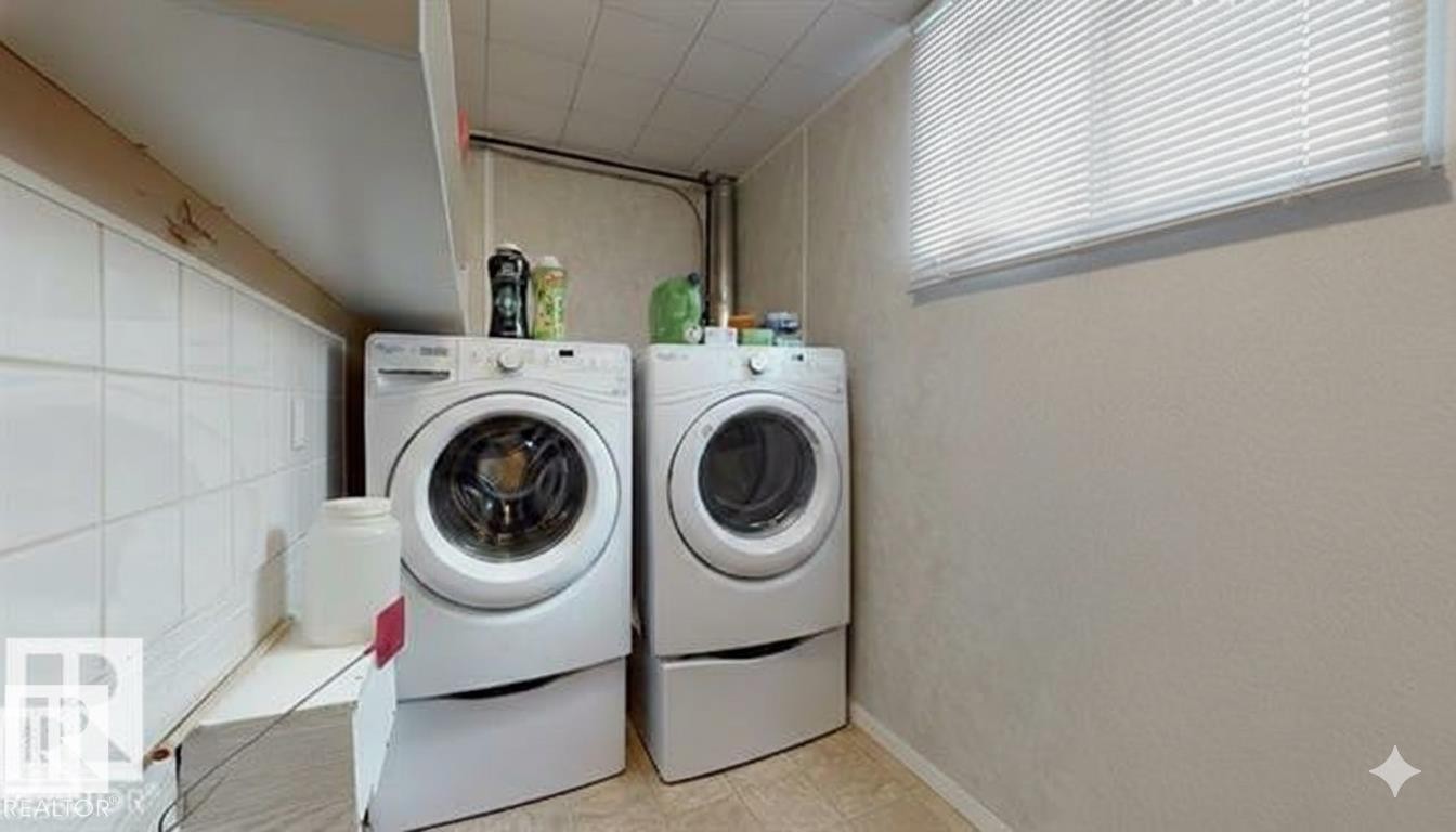 Laundry area with independent washer and dryer - 4706 53 St, Leduc, AB - Indoor Photo Showing Laundry Room