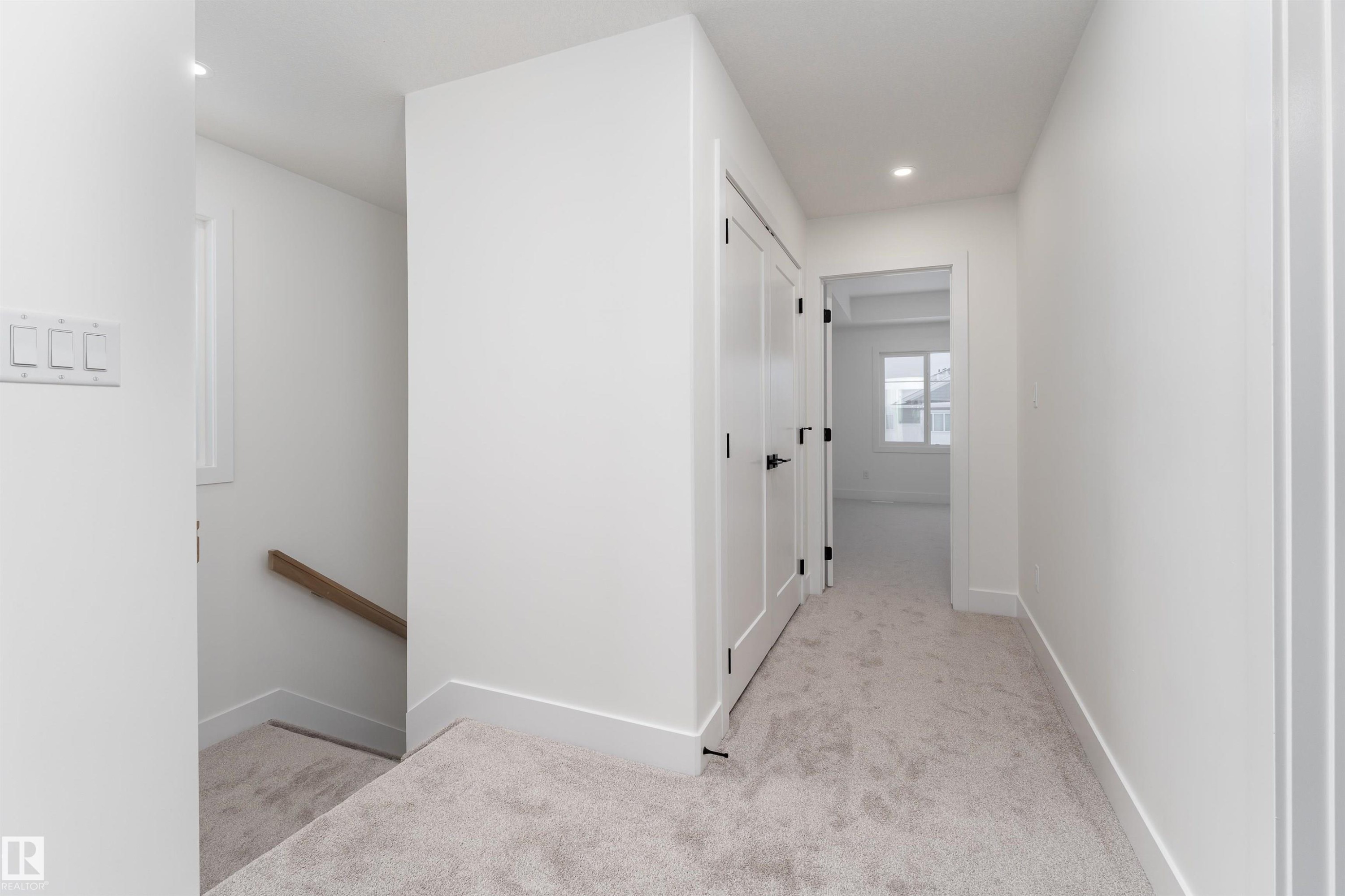 Corridor featuring light colored carpet, an upstairs landing, and recessed lighting - 3103 Magpie Way, Edmonton, AB - Indoor Photo Showing Other Room
