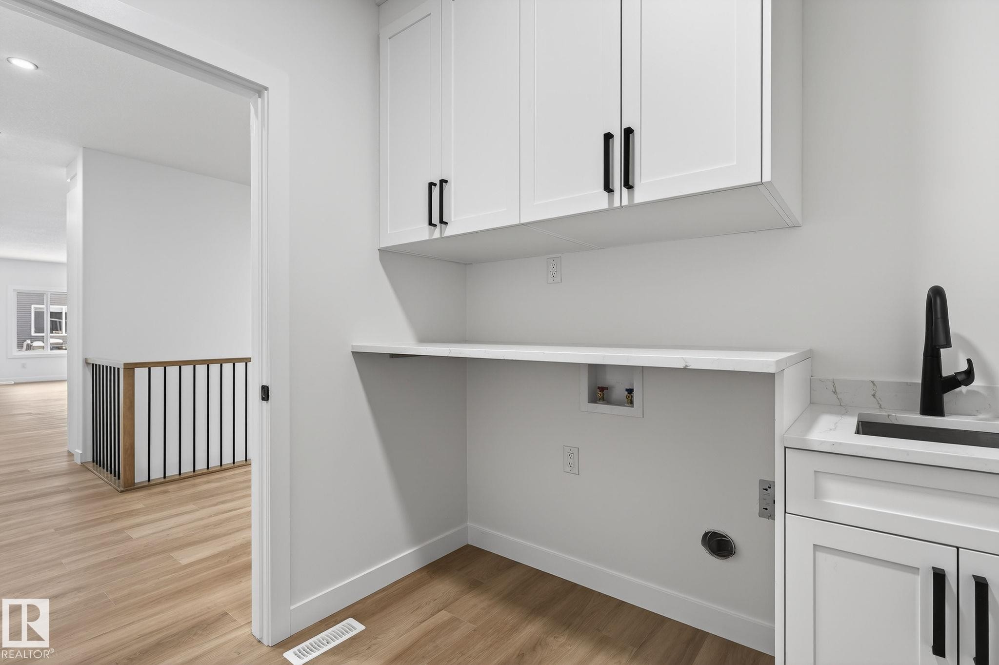 Laundry area featuring cabinet space, light wood-style floors, washer hookup, and recessed lighting - 3318 Chickadee Drive, Edmonton, AB - Indoor
