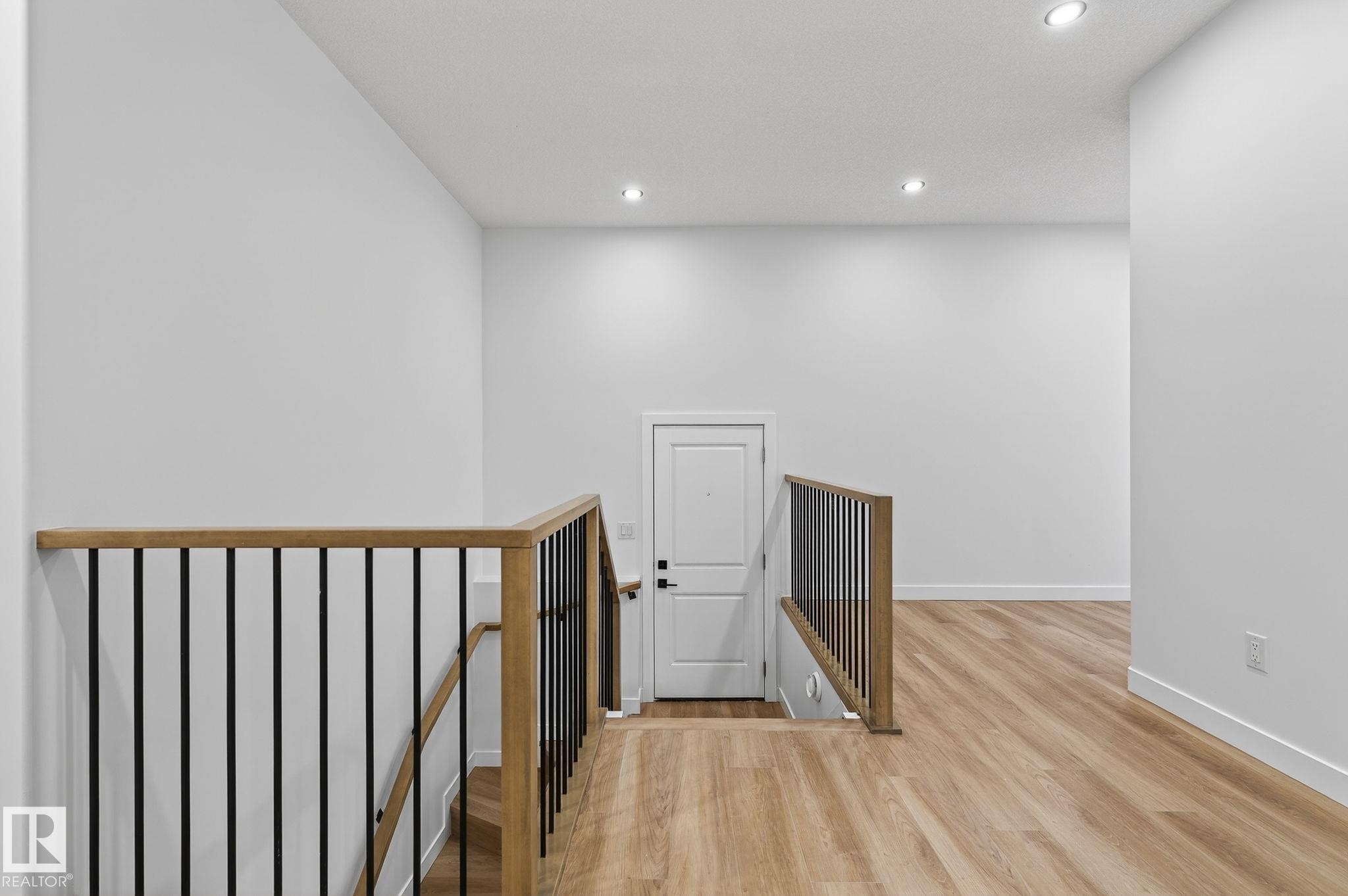 Hallway featuring an upstairs landing, light wood-type flooring, and recessed lighting - 3318 Chickadee Drive, Edmonton, AB - Indoor Photo Showing Other Room