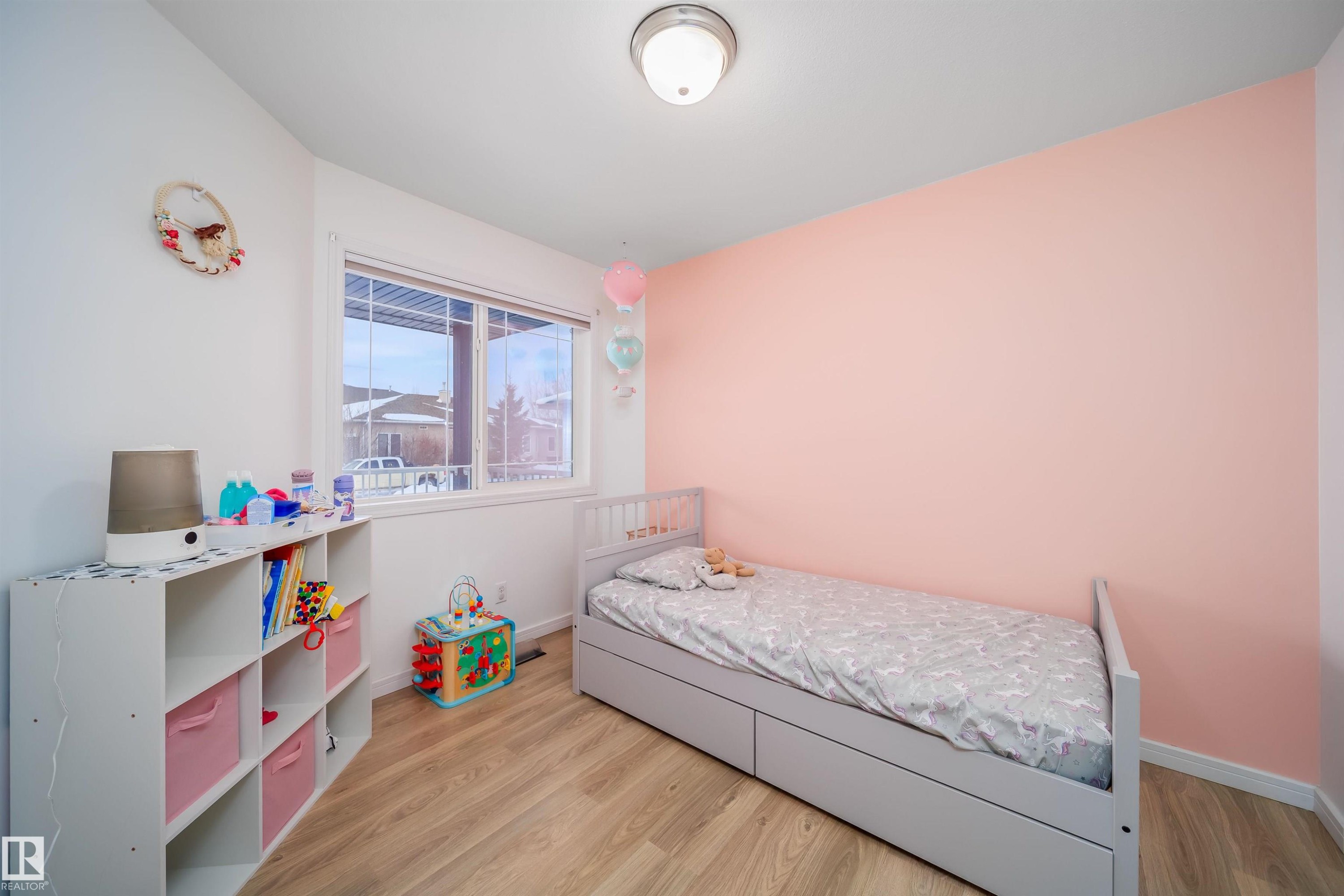 Bedroom featuring light wood-style flooring - 1179 Oakland Drive, Devon, AB - Indoor Photo Showing Bedroom