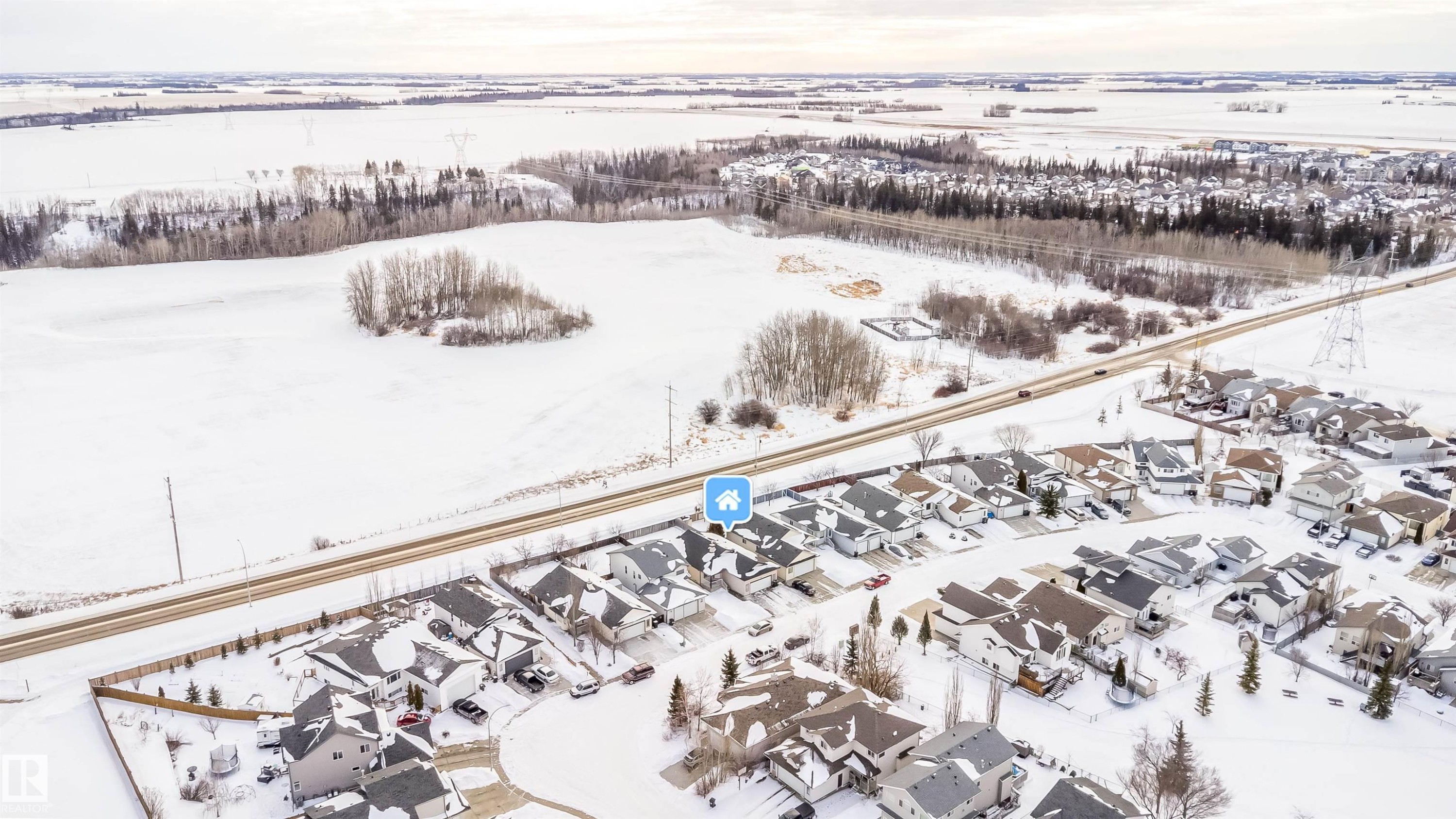 Snowy aerial view with a residential view - 1179 Oakland Drive, Devon, AB - Outdoor With View