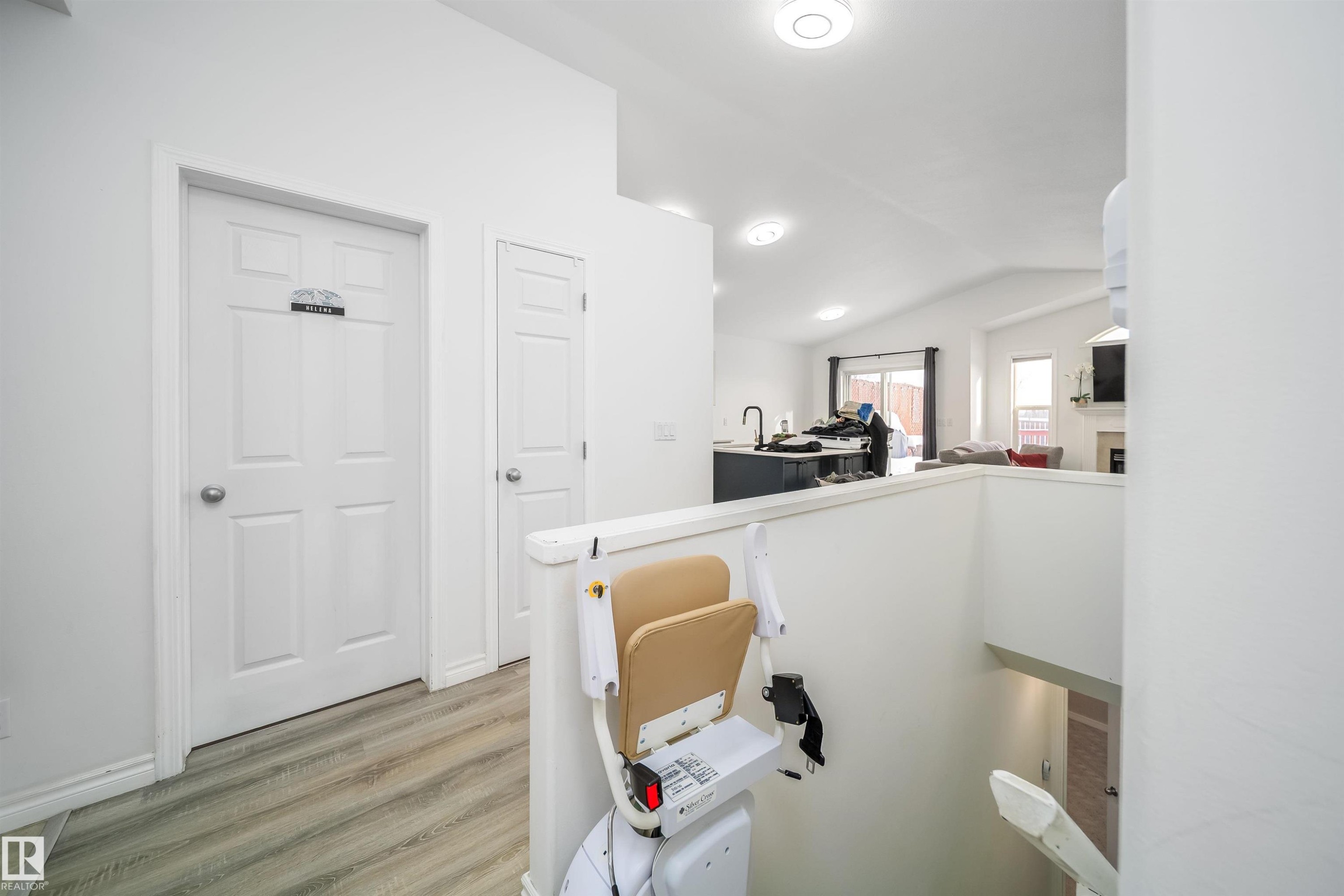 Office area featuring lofted ceiling, light wood-style flooring, and a fireplace - 1179 Oakland Drive, Devon, AB - Indoor Photo Showing Other Room