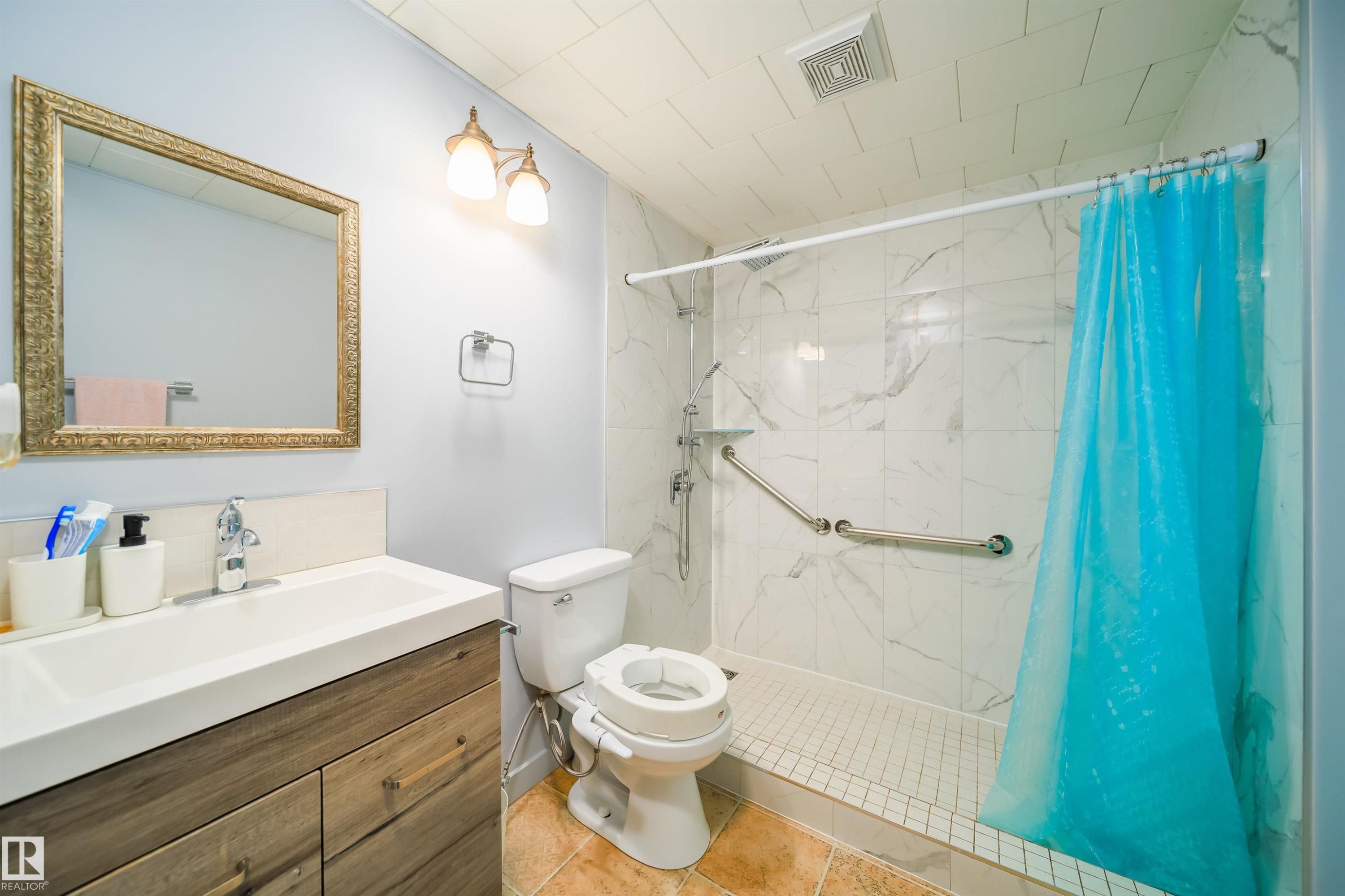Full bathroom with vanity, a marble finish shower, and light tile patterned floors - 1179 Oakland Drive, Devon, AB - Indoor Photo Showing Bathroom