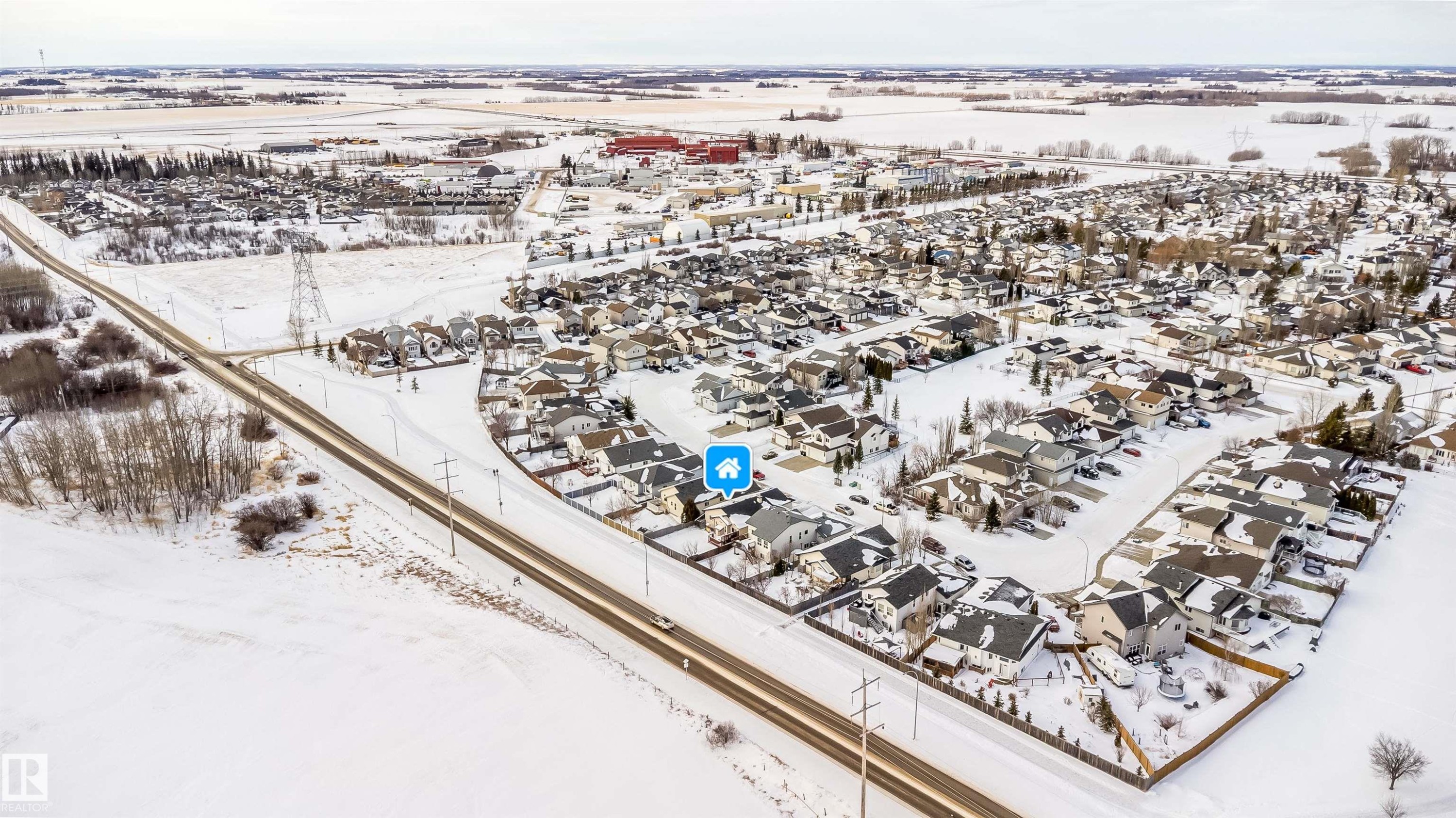 Snowy aerial view featuring a residential view - 1179 Oakland Drive, Devon, AB - Outdoor With View