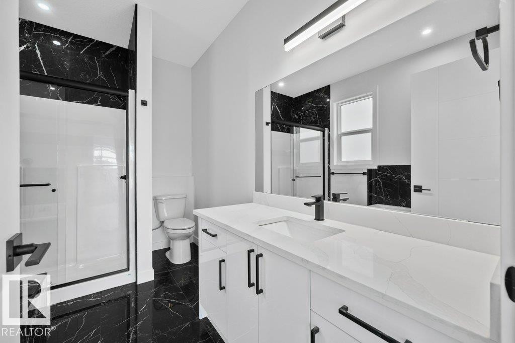 Bathroom with a marble finish shower, vanity, and recessed lighting - Edmonton, AB - Indoor Photo Showing Bathroom