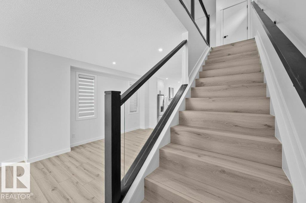 Stairway featuring wood finished floors and recessed lighting - Edmonton, AB - Indoor Photo Showing Other Room