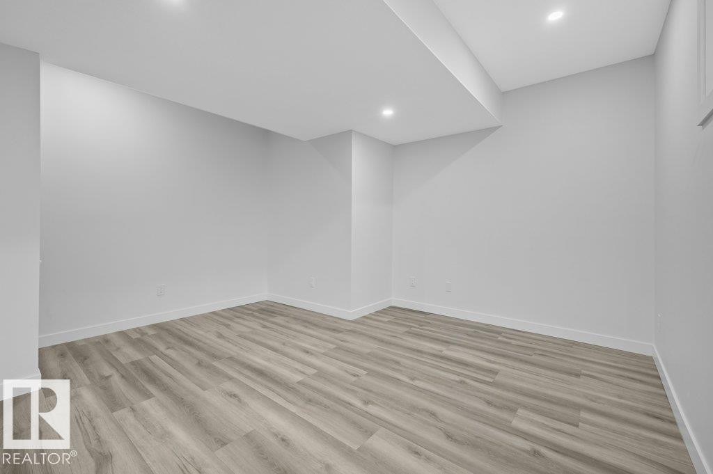 Unfurnished room with light wood-style flooring and recessed lighting - Edmonton, AB - Indoor Photo Showing Other Room