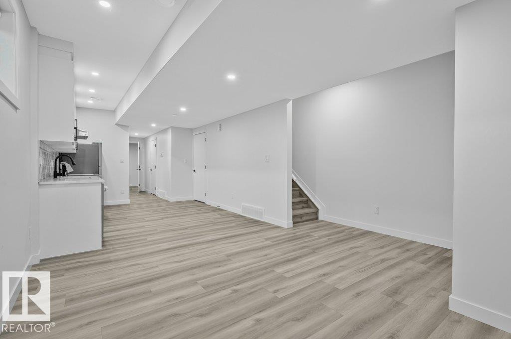 Unfurnished living room featuring recessed lighting and light wood-type flooring - Edmonton, AB - Indoor Photo Showing Other Room