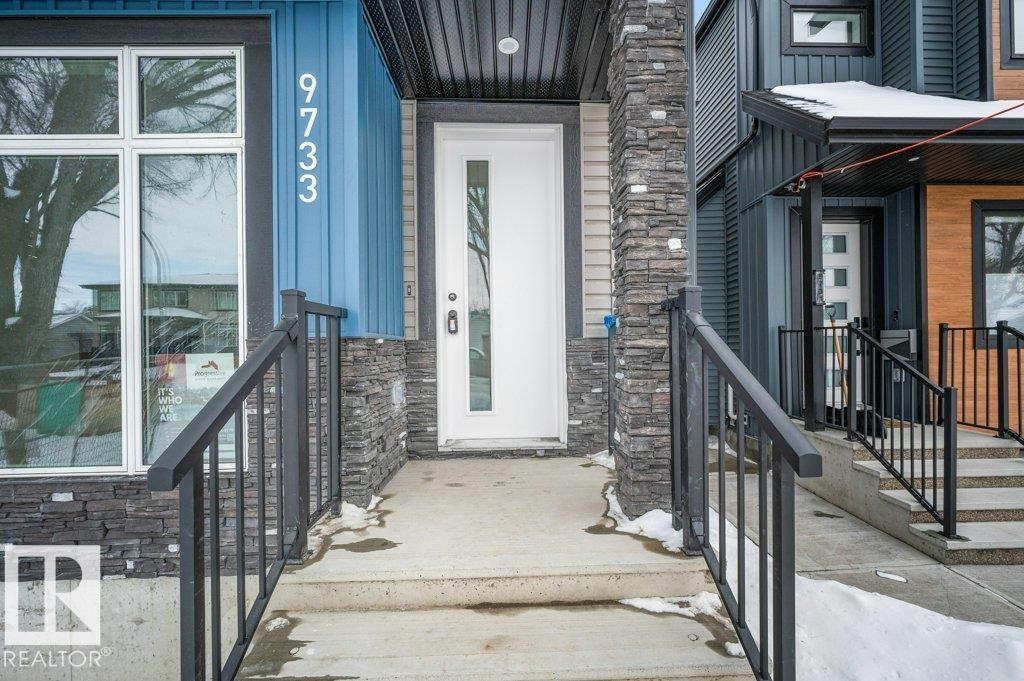 Entrance to property featuring stone siding and board and batten siding - Edmonton, AB - Outdoor