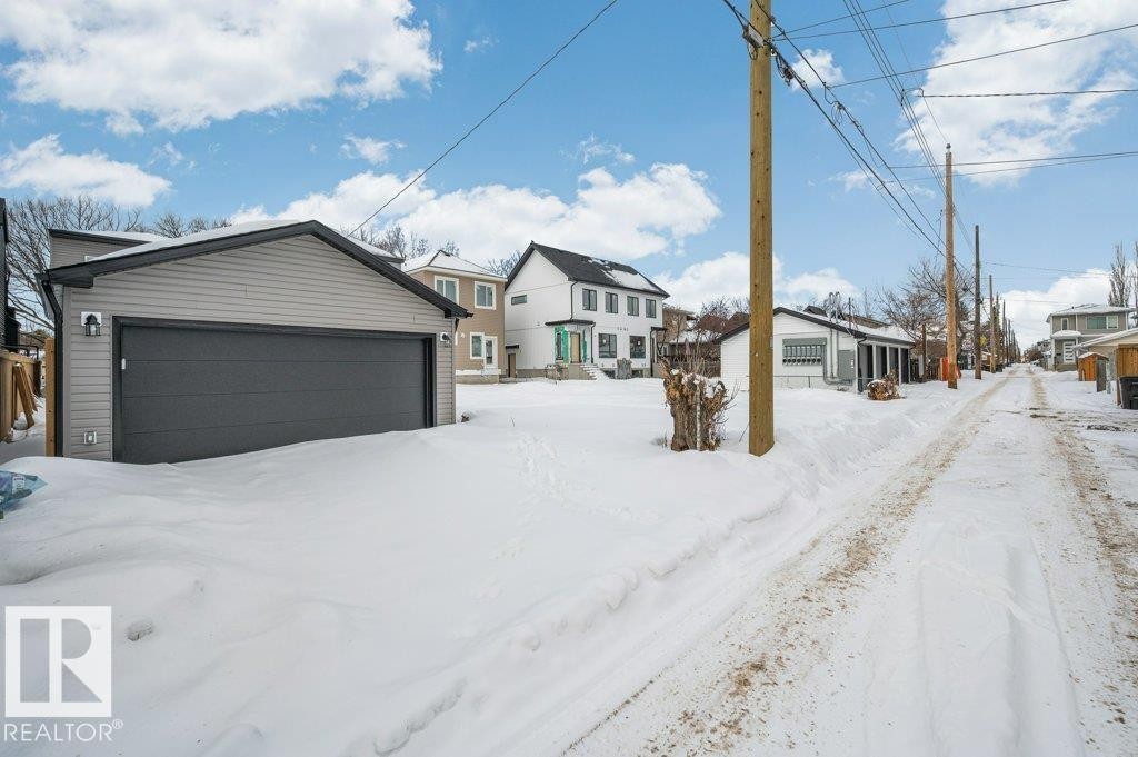 Traditional home featuring an outdoor structure, a residential view, and a detached garage - Edmonton, AB - Outdoor