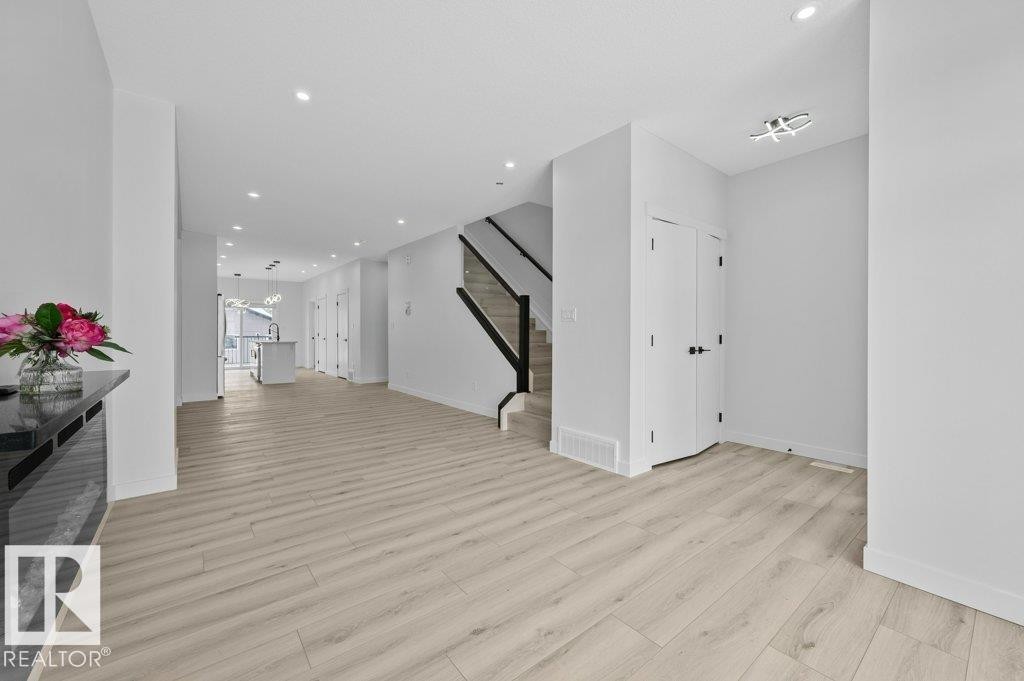 Unfurnished living room with recessed lighting and light wood-type flooring - Edmonton, AB - Indoor Photo Showing Other Room