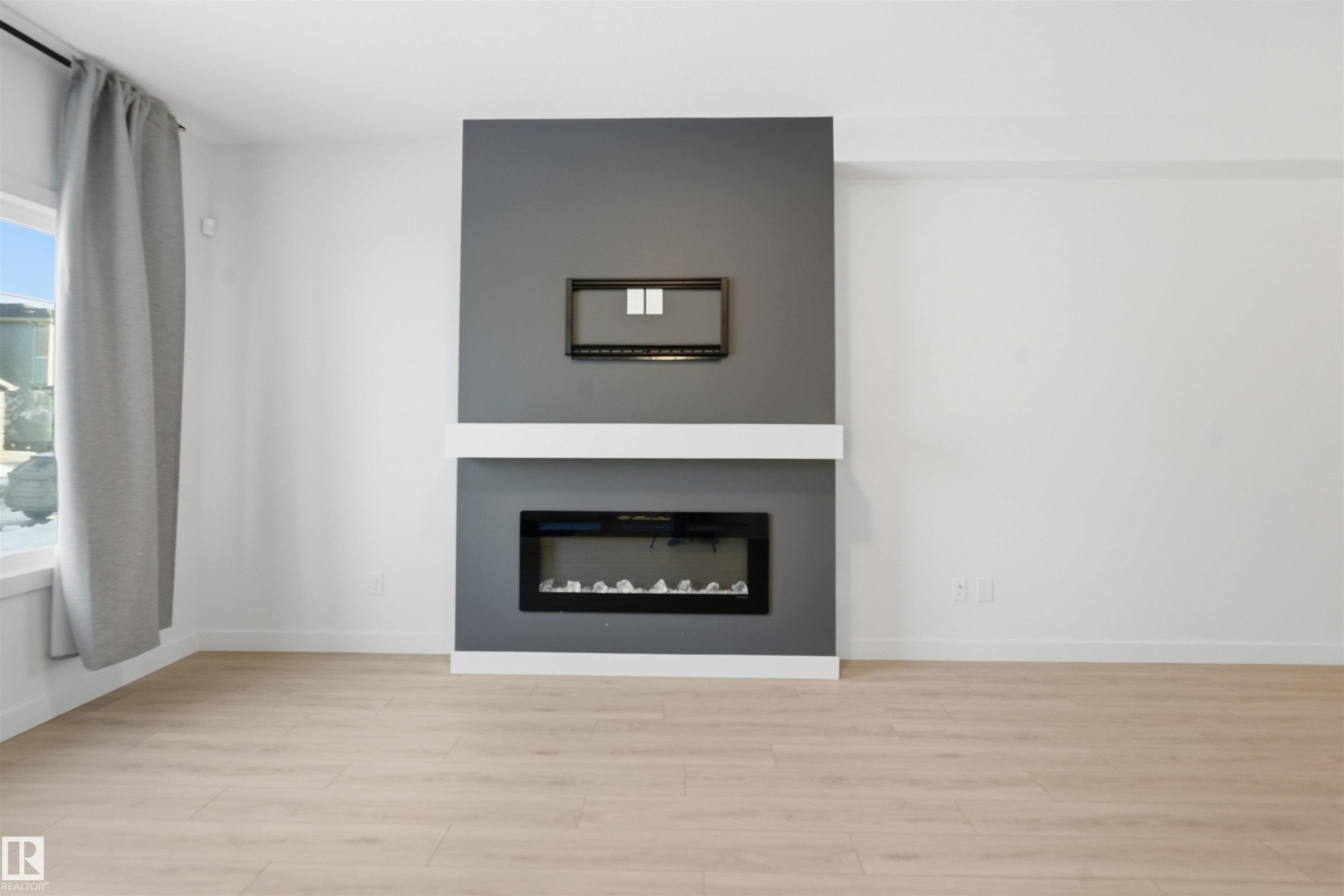 317 Juniper Cove, Leduc, AB - Indoor Photo Showing Living Room With Fireplace