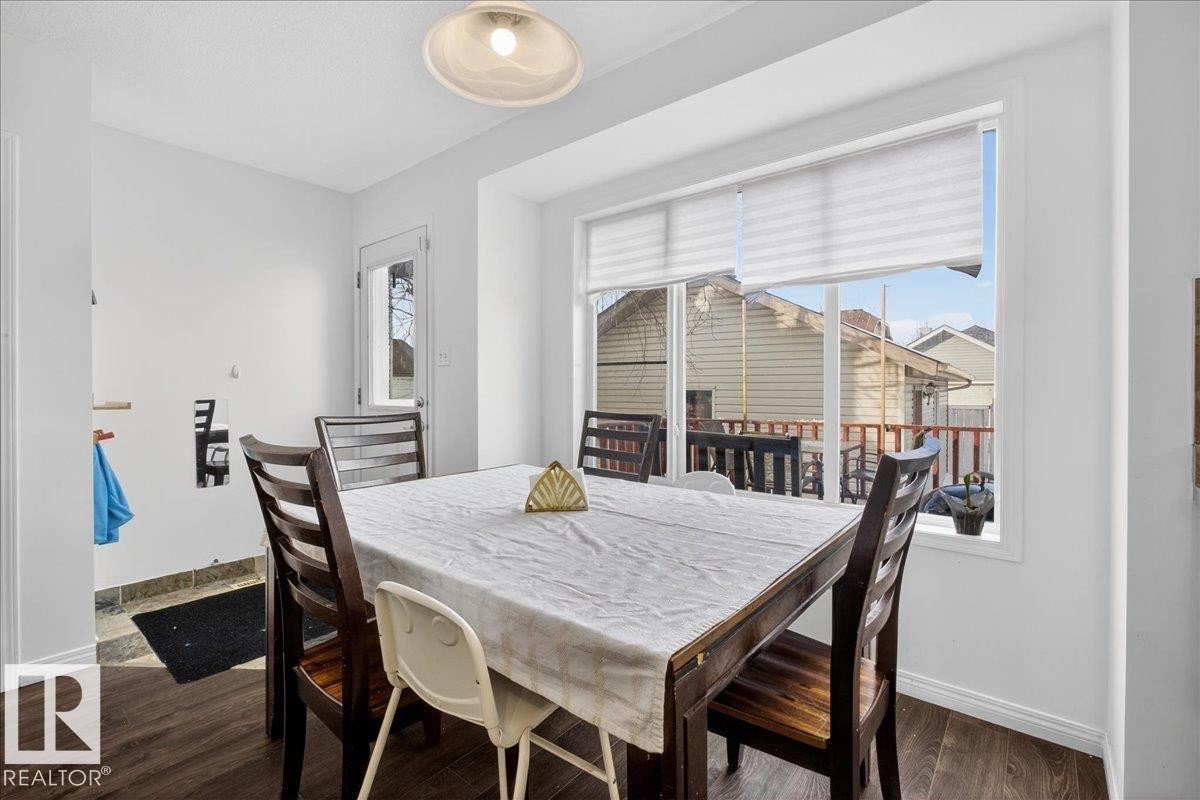 Dining area featuring baseboards and dark wood-style flooring - 4519 Turner Square, Edmonton, AB - Indoor Photo Showing Dining Room