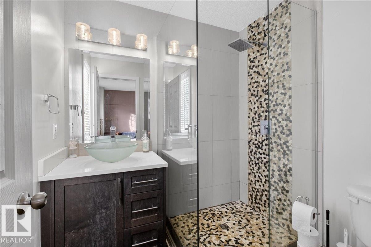 Full bathroom with a stall shower, vanity, and a textured ceiling - 4519 Turner Square, Edmonton, AB - Indoor Photo Showing Bathroom