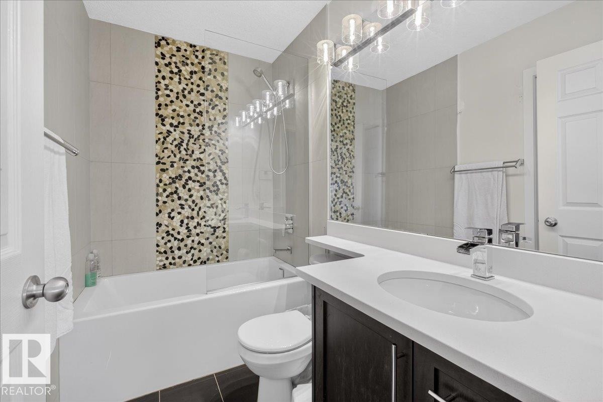Bathroom with vanity and bathtub / shower combination - 4519 Turner Square, Edmonton, AB - Indoor Photo Showing Bathroom
