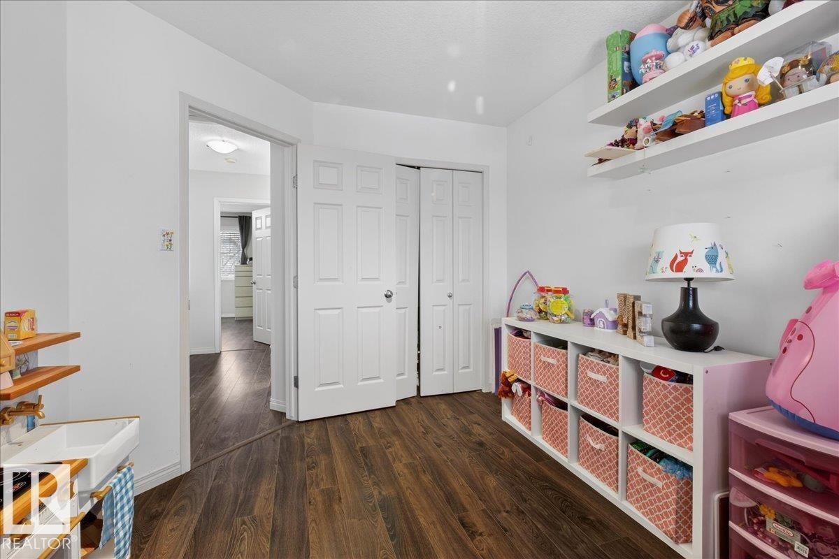 Game room with dark wood finished floors and baseboards - 4519 Turner Square, Edmonton, AB - Indoor