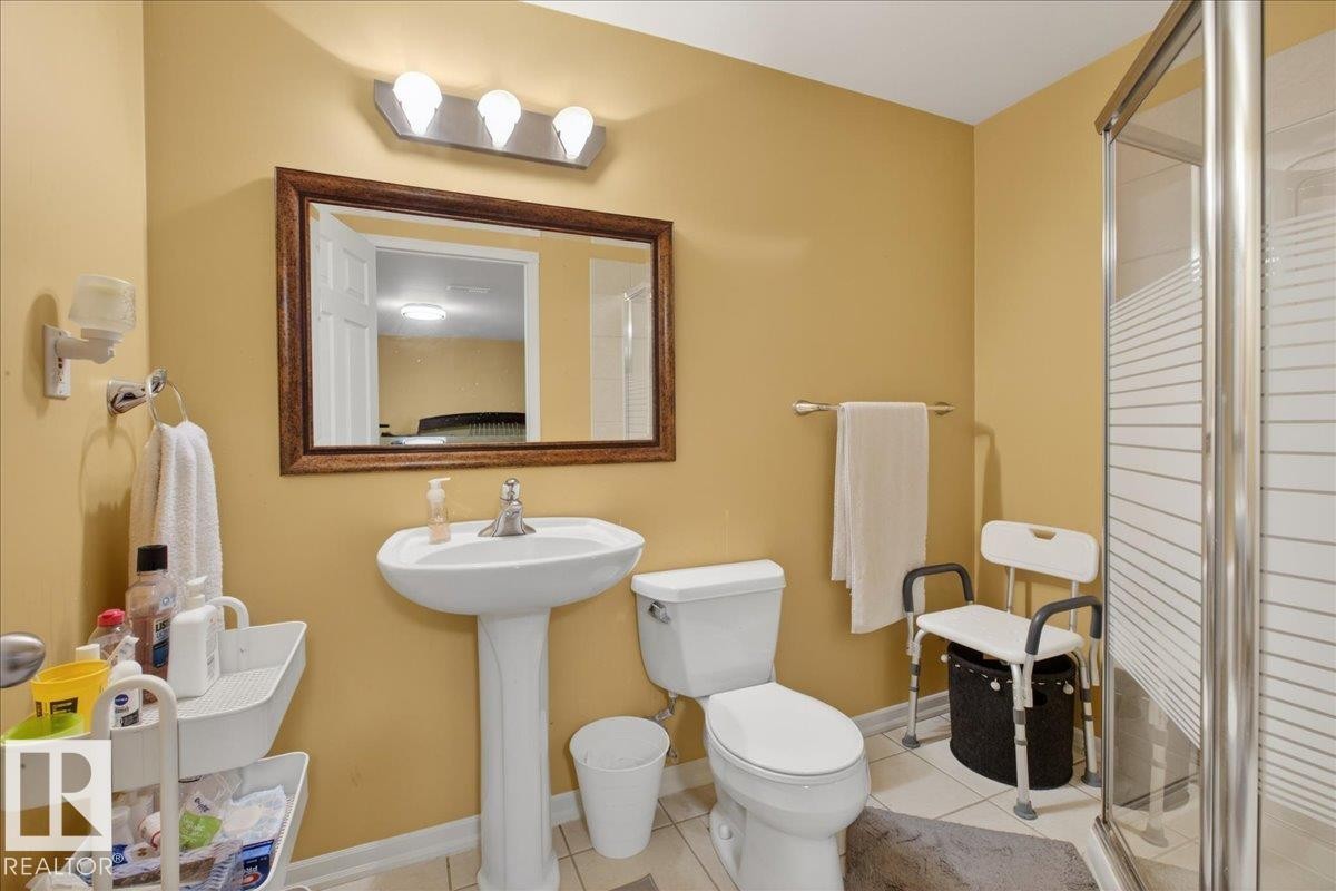 Full bath with a stall shower and light tile patterned flooring - 4519 Turner Square, Edmonton, AB - Indoor Photo Showing Bathroom