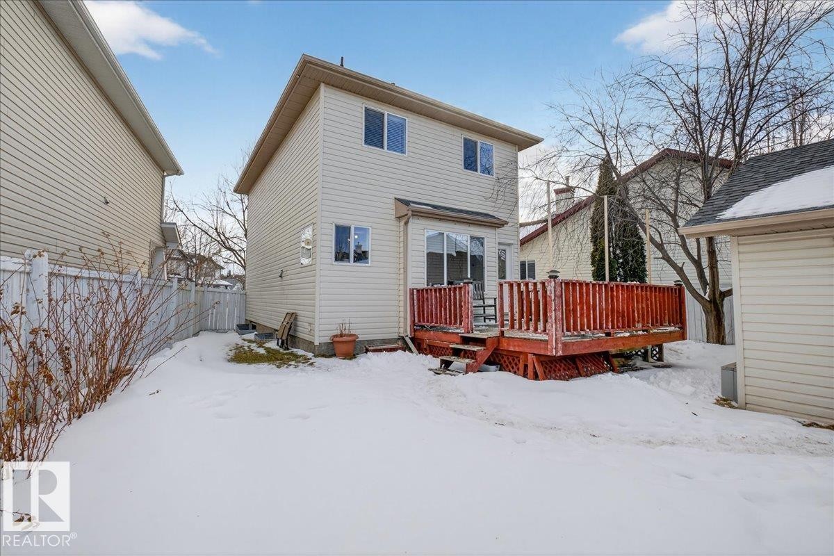 Snow covered back of property featuring a deck - 4519 Turner Square, Edmonton, AB - Outdoor With Deck Patio Veranda With Exterior