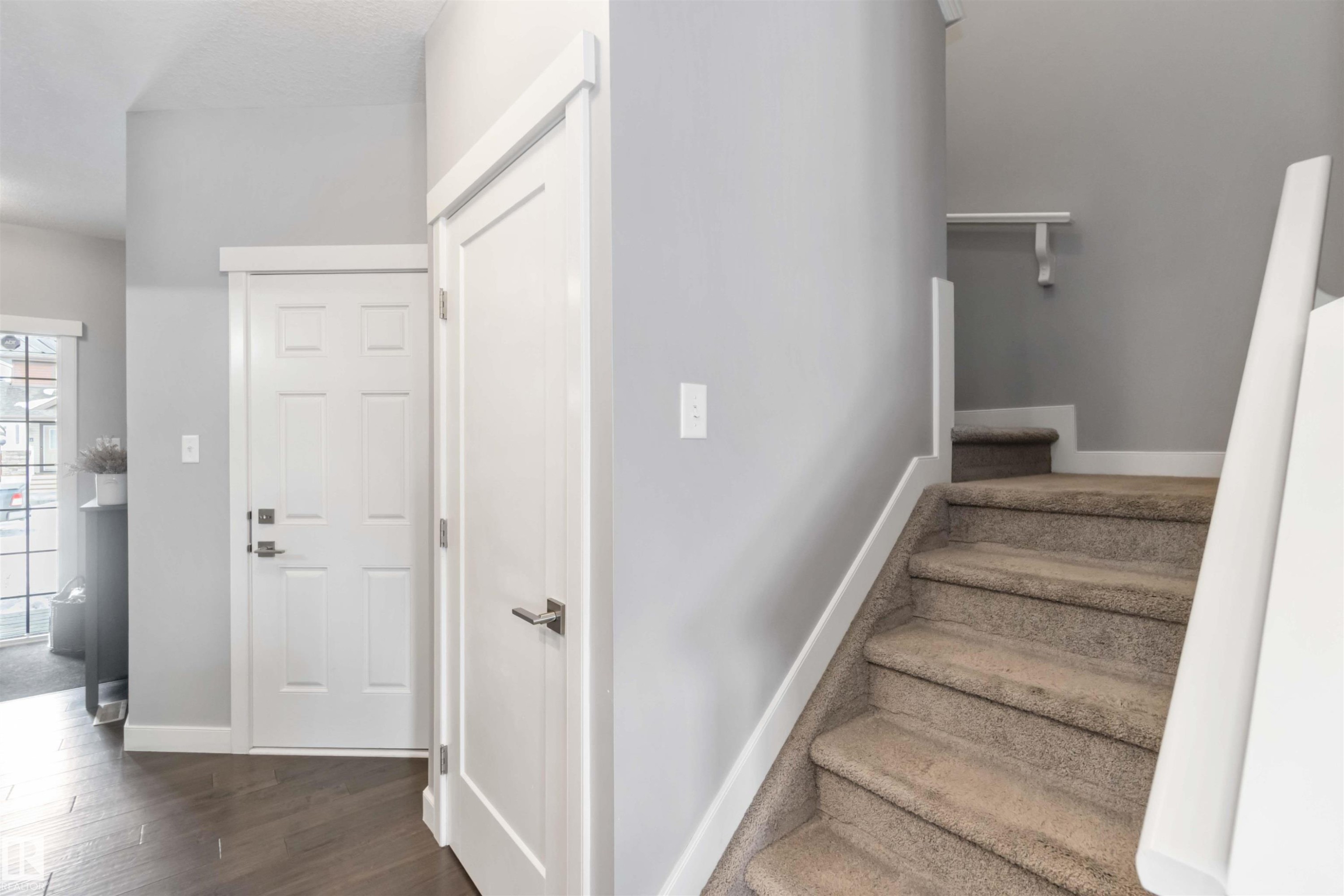 Stairway with baseboards and wood finished floors - 17143 38 Street, Edmonton, AB - Indoor Photo Showing Other Room