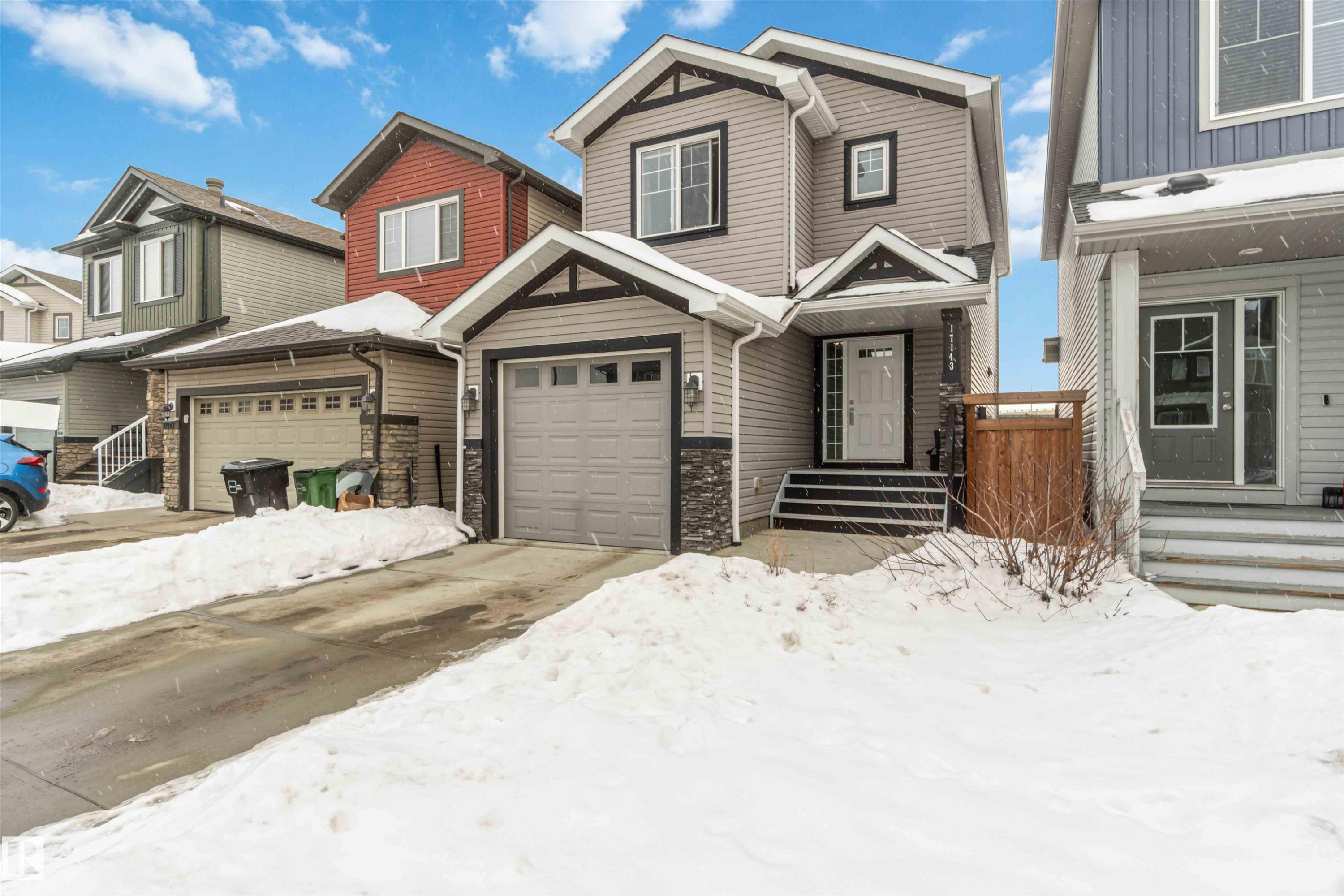 View of front of property featuring concrete driveway and stone siding - 17143 38 Street, Edmonton, AB - Outdoor With Facade