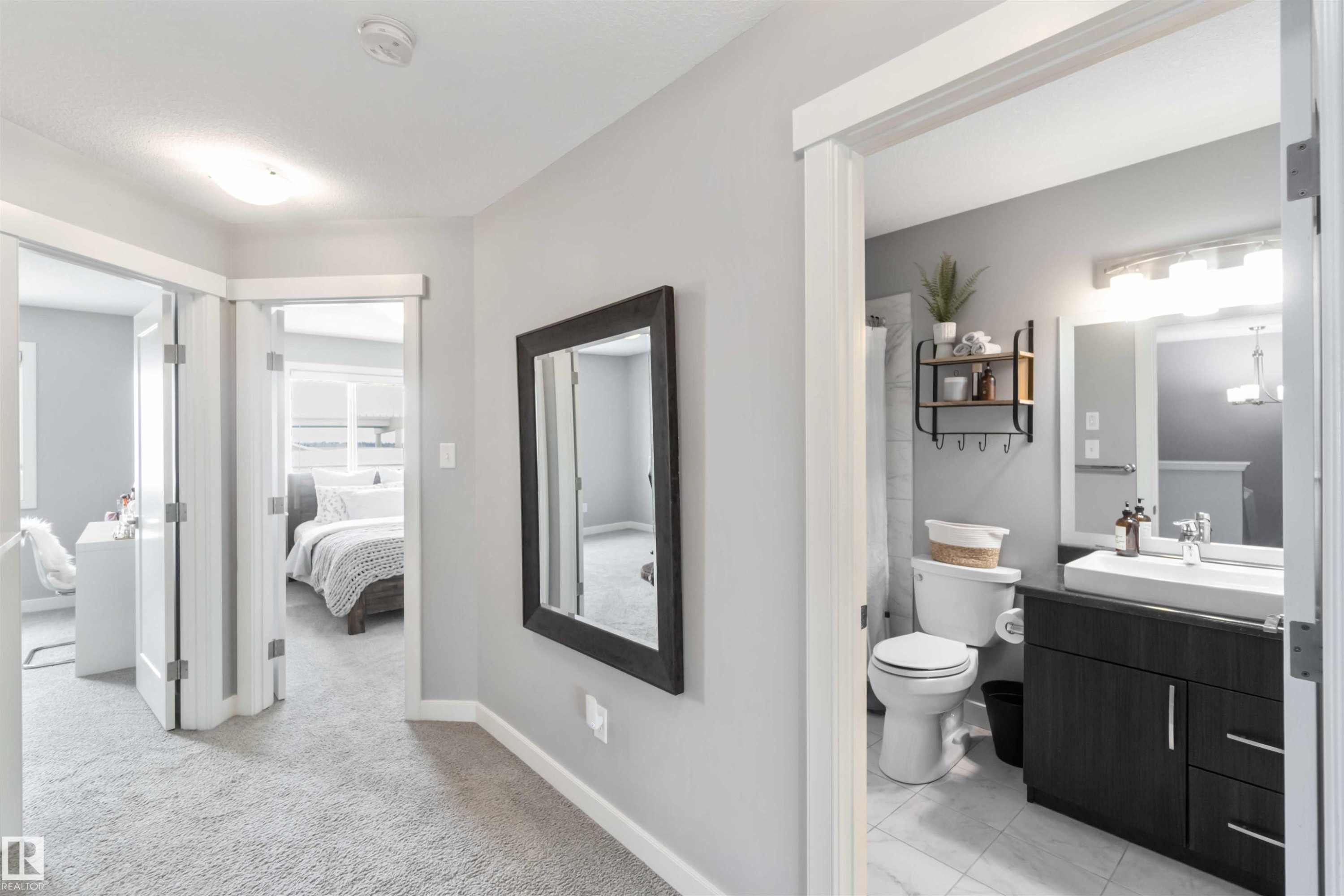 Ensuite bathroom with vanity, curtained shower, and light carpet - 17143 38 Street, Edmonton, AB - Indoor Photo Showing Bathroom