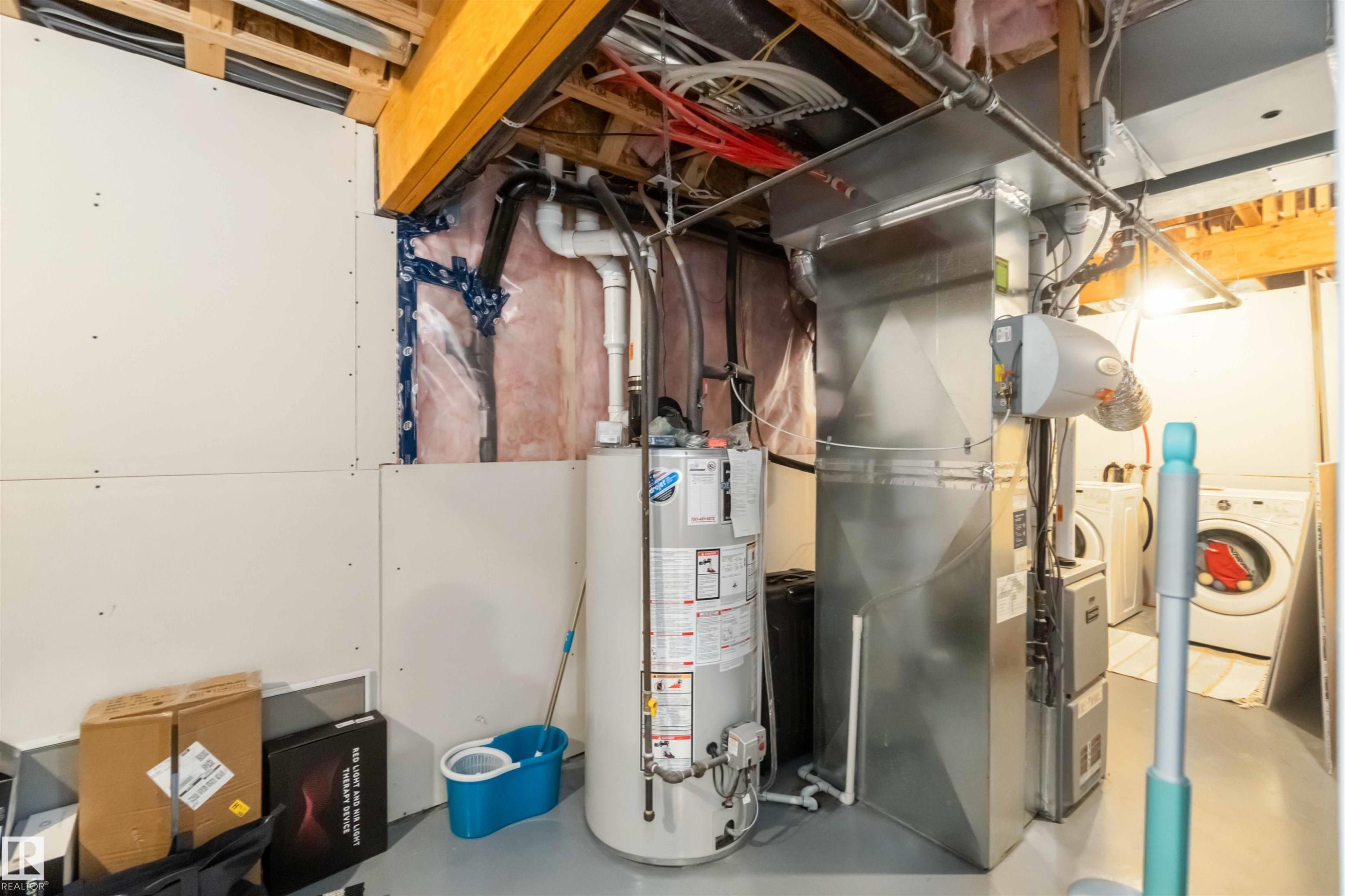 Utility room with water heater, washer / clothes dryer, and heating unit - 17143 38 Street, Edmonton, AB - Indoor Photo Showing Basement